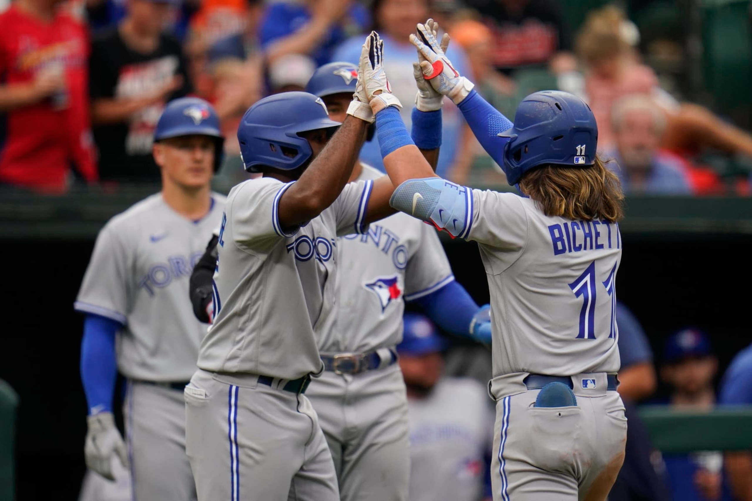 Toronto Blue Jays' Bo Bichette, right, celebrates with Jackie Bradley Jr., left, after Bichette hit a three-run home run off Baltimore Orioles relief pitcher Nick Vespi during the third inning of the second game of a baseball doubleheader, Monday, Sept. 5, 2022, in Baltimore. Bradley Jr. and teammate George Springer scored on the home run. (AP Photo/Julio Cortez)
