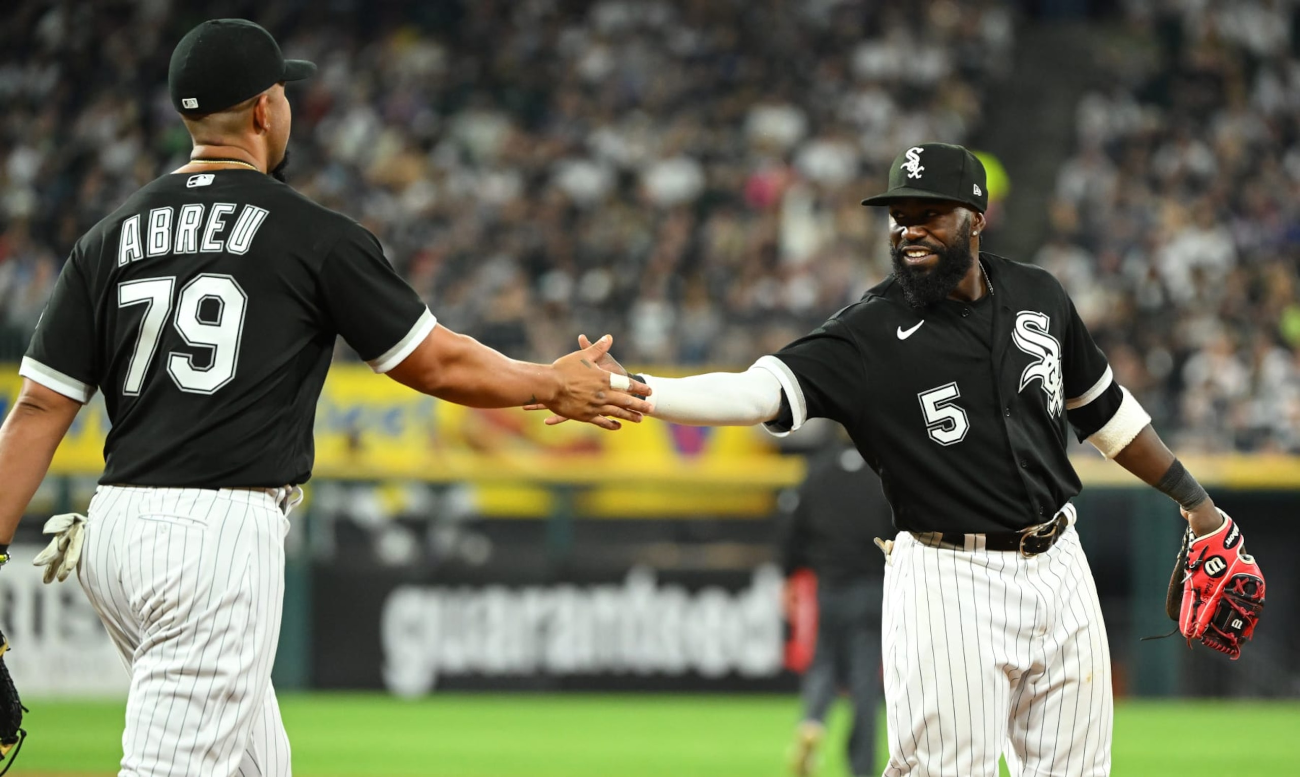 CHICAGO - MAY 14:  Josh Harrison #5 celebrates with Jose Abreu #79 of the Chicago White Sox after making a nice defensive play against the New York Yankees on May 14, 2022 at Guaranteed Rate Field in Chicago, Illinois.  (Photo by Ron Vesely/Getty Images)