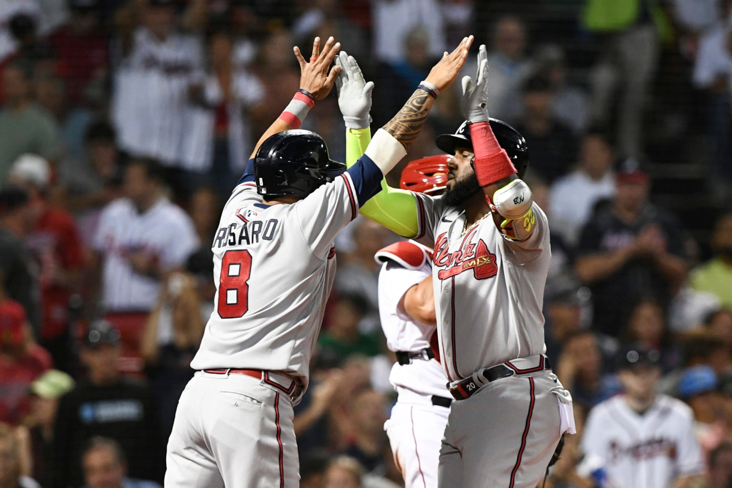 BOSTON, MASSACHUSETTS - AUGUST 10: Marcell Ozuna #20 of the Atlanta Braves celebrates with Eddie Rosario #8 after hitting a three-run home run against the Boston Red Sox during the fourth inning at Fenway Park on August 10, 2022 in Boston, Massachusetts. (Photo by Brian Fluharty/Getty Images)