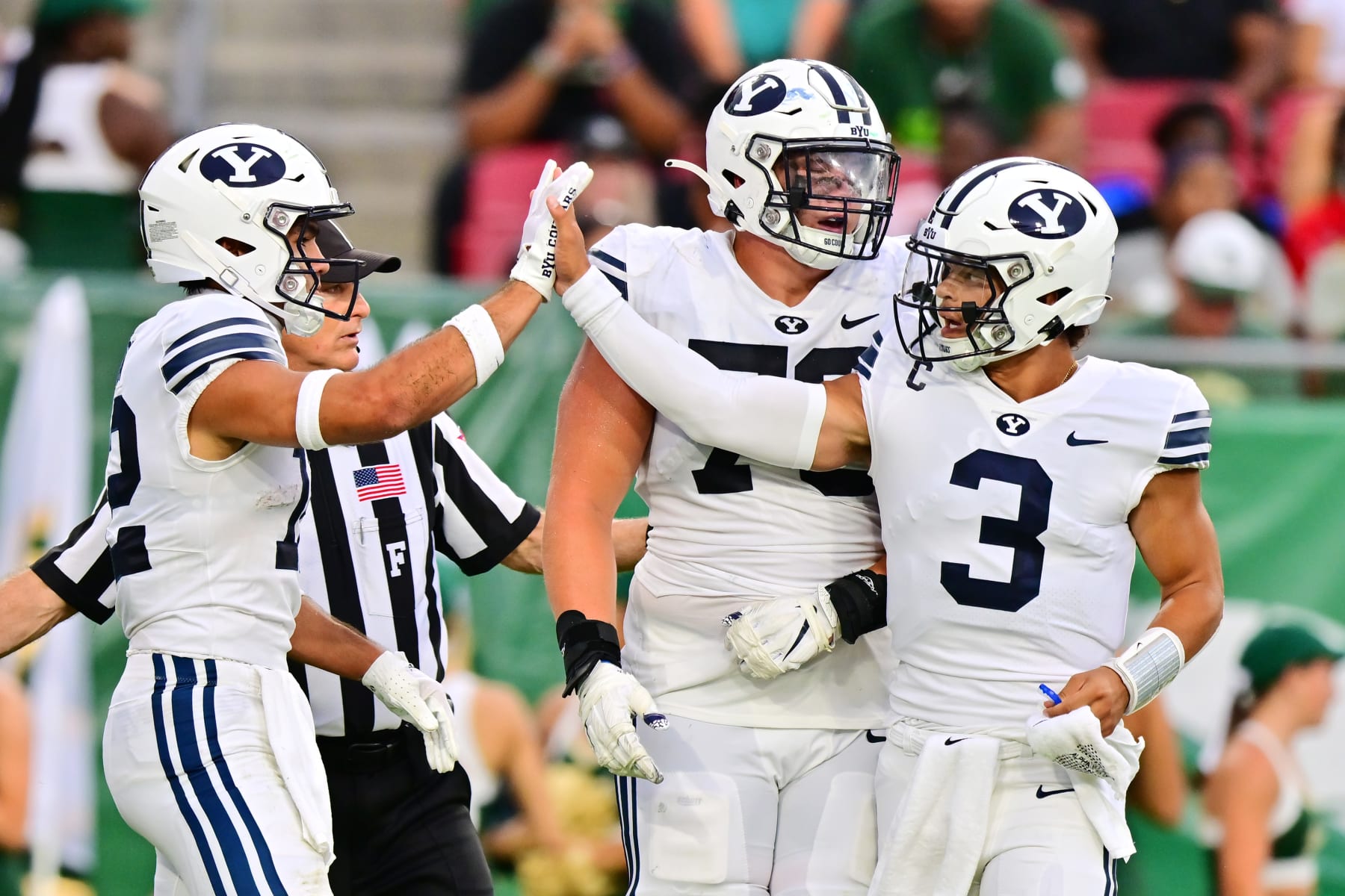 TAMPA, FLORIDA - SEPTEMBER 03: Jaren Hall #3 of the Brigham Young Cougars high fives teammate Puka Nacua #12 after a touchdown in the first quarter against the South Florida Bulls at Raymond James Stadium on September 03, 2022 in Tampa, Florida. (Photo by Julio Aguilar/Getty Images)