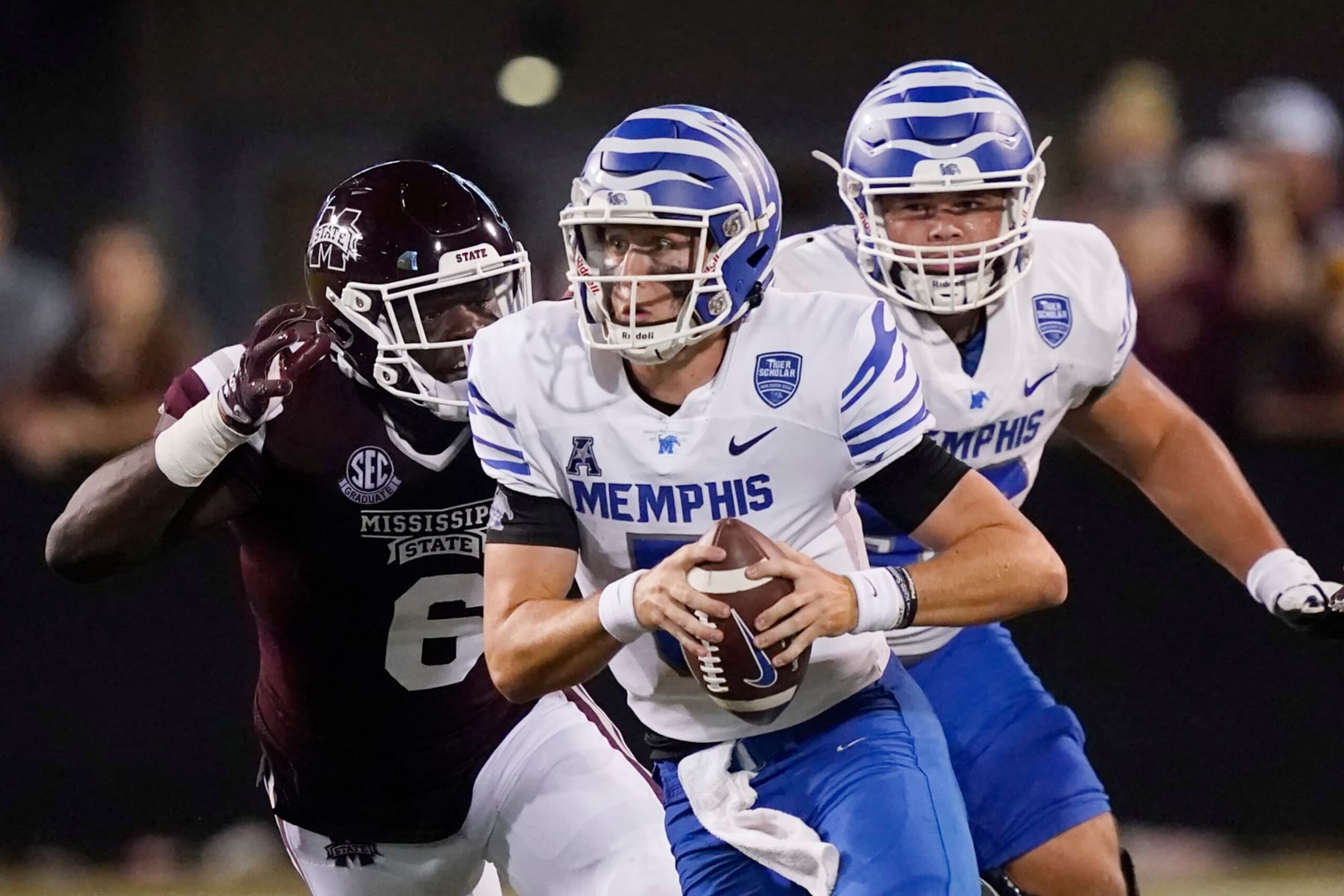 Mississippi State defensive end Jordan Davis (6) pressures Memphis quarterback Seth Henigan (5) during the second half of an NCAA college football game in Starkville, Miss., Saturday, Sept. 3, 2022. Mississippi State won 49-23. (AP Photo/Rogelio V. Solis)