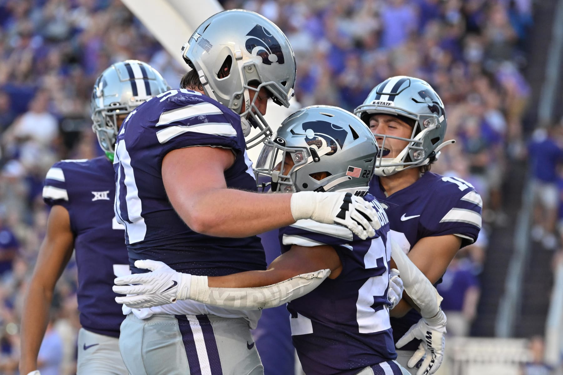 MANHATTAN, KS - SEPTEMBER 03:  Running back Deuce Vaughn #22 of the Kansas State Wildcats celebrates with his teammates after scoring a touchdown against the South Dakota Coyotes during the first half at Bill Snyder Family Football Stadium on September 03, 2022 in Manhattan, Kansas. (Photo by Peter Aiken/Getty Images)