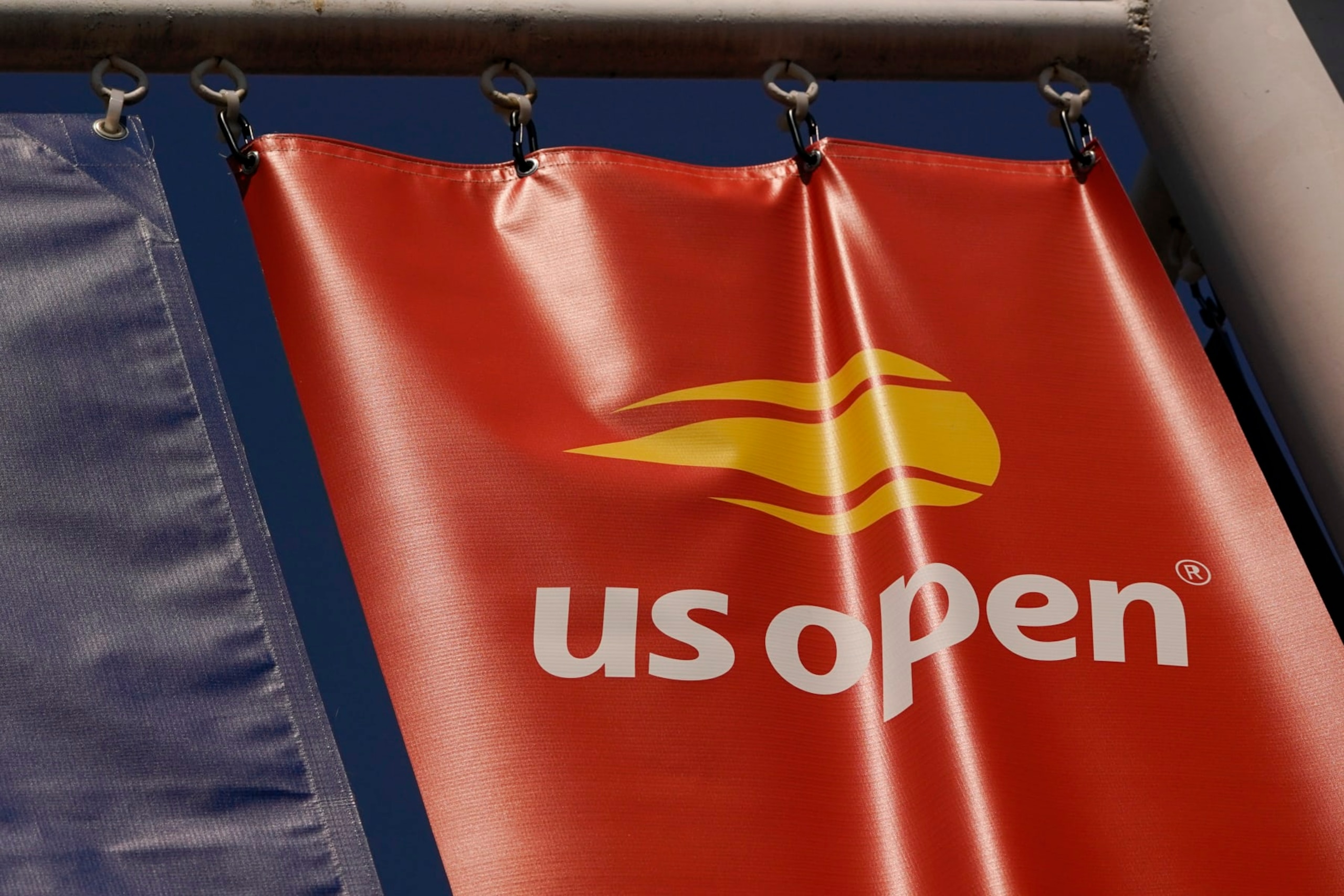 A logo is displayed on the grounds of the U.S. Open tennis tournament in New York, Thursday, Aug. 25, 2022. (AP Photo/Seth Wenig)