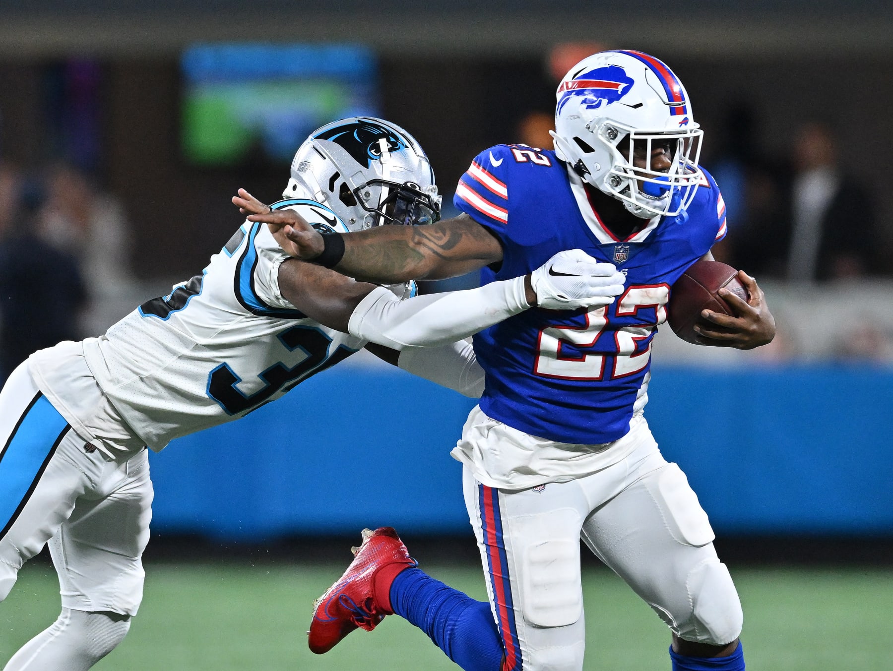 CHARLOTTE, NORTH CAROLINA - AUGUST 26:  Kalon Barnes #35 of the Carolina Panthers dives to tackle Duke Johnson #22 of the Buffalo Bills during the third quarter of a preseason game at Bank of America Stadium on August 26, 2022 in Charlotte, North Carolina. (Photo by Grant Halverson/Getty Images)