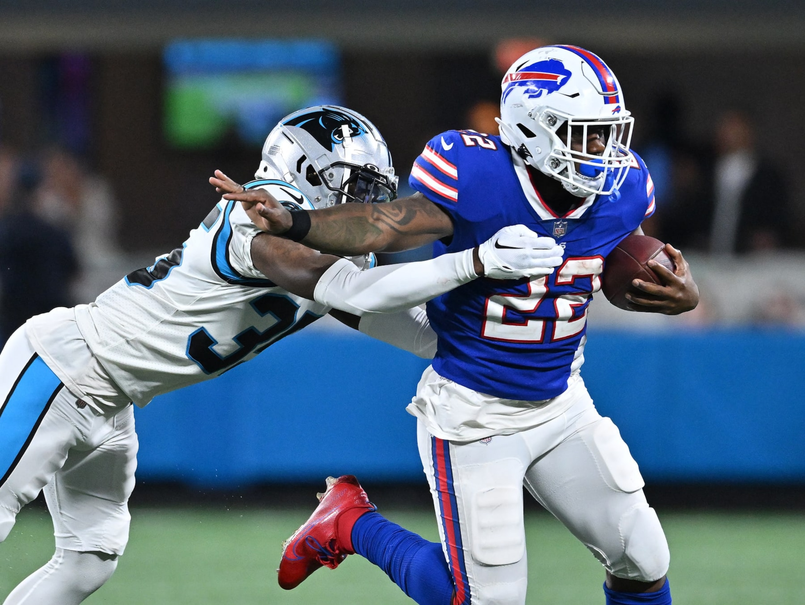CHARLOTTE, NORTH CAROLINA - AUGUST 26:  Kalon Barnes #35 of the Carolina Panthers dives to tackle Duke Johnson #22 of the Buffalo Bills during the third quarter of a preseason game at Bank of America Stadium on August 26, 2022 in Charlotte, North Carolina. (Photo by Grant Halverson/Getty Images)