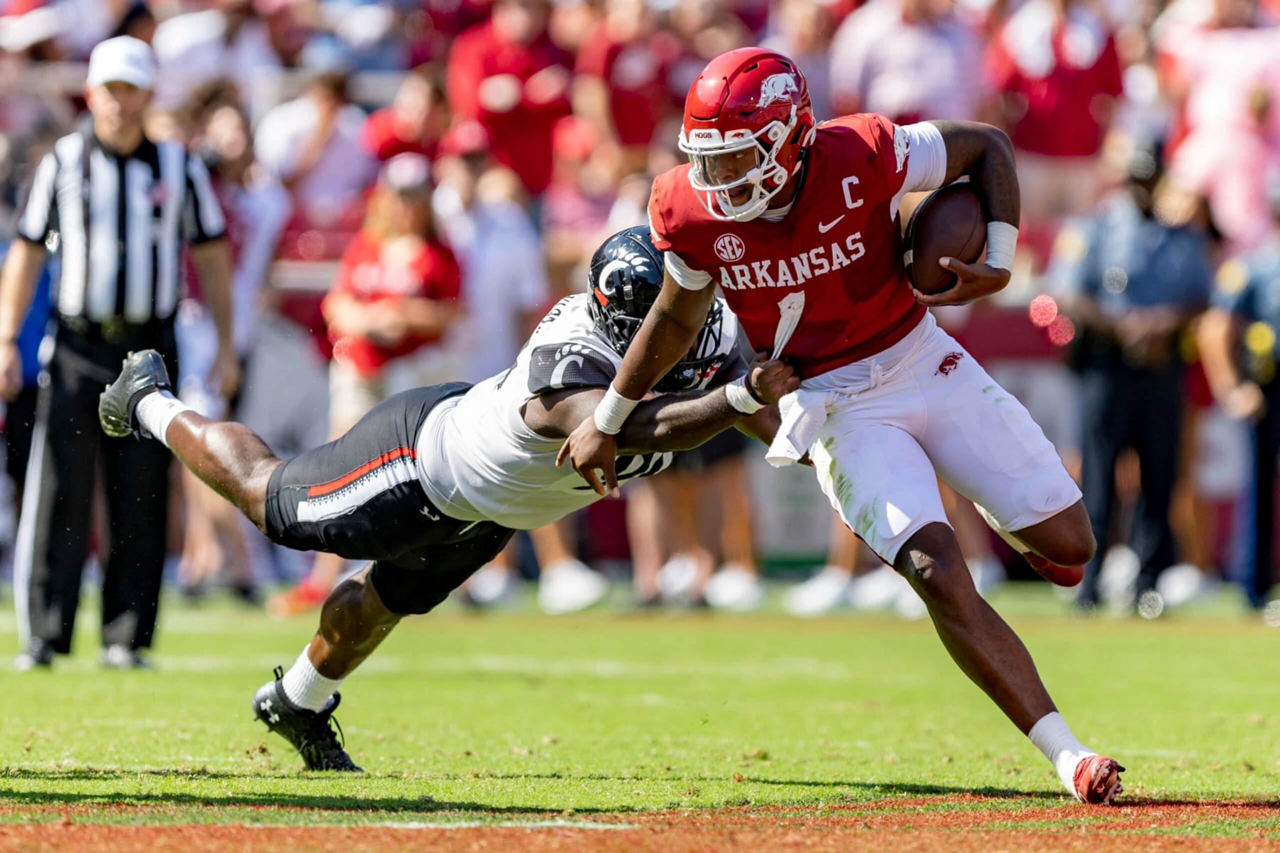 FAYETTEVILLE, ARKANSAS - SEPTEMBER 03: K.J. Jefferson #1 of the Arkansas Razorbacks runs the ball and is tackled by Jabari Taylor #90 of the Cincinnati Bearcats at Donald W. Reynolds Razorback Stadium on September 03, 2022 in Fayetteville, Arkansas. The Razorbacks defeated the Bearcats 31-24. (Photo by Wesley Hitt/Getty Images FAYETTEVILLE, ARKANSAS - SEPTEMBER 03: K.J. Jefferson #1 of the Arkansas Razorbacks runs the ball and is tackled by Jabari Taylor #90 of the Cincinnati Bearcats at Donald W. Reynolds Razorback Stadium on September 03, 2022 in Fayetteville, Arkansas. The Razorbacks defeated the Bearcats 31-24. (Photo by Wesley Hitt/Getty Images