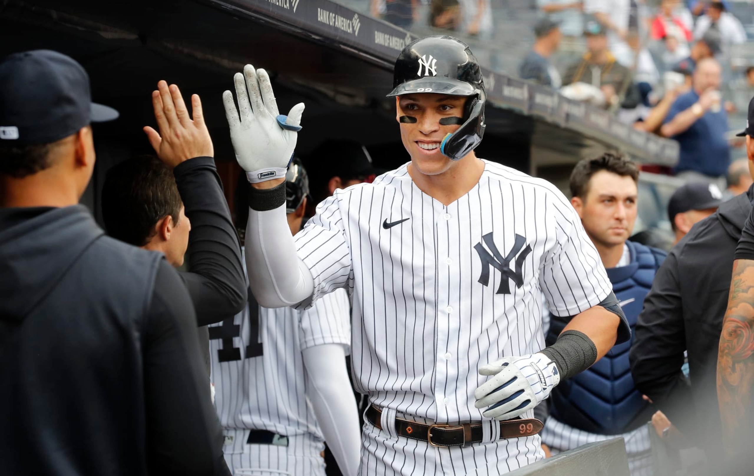 NEW YORK, NEW YORK - SEPTEMBER 07:  Aaron Judge #99 of the New York Yankees celebrates his fourth inning home run during game one of a doubleheader against the Minnesota Twins in the dugout with his teammates at Yankee Stadium on September 07, 2022 in the Bronx borough of New York City. (Photo by Jim McIsaac/Getty Images)