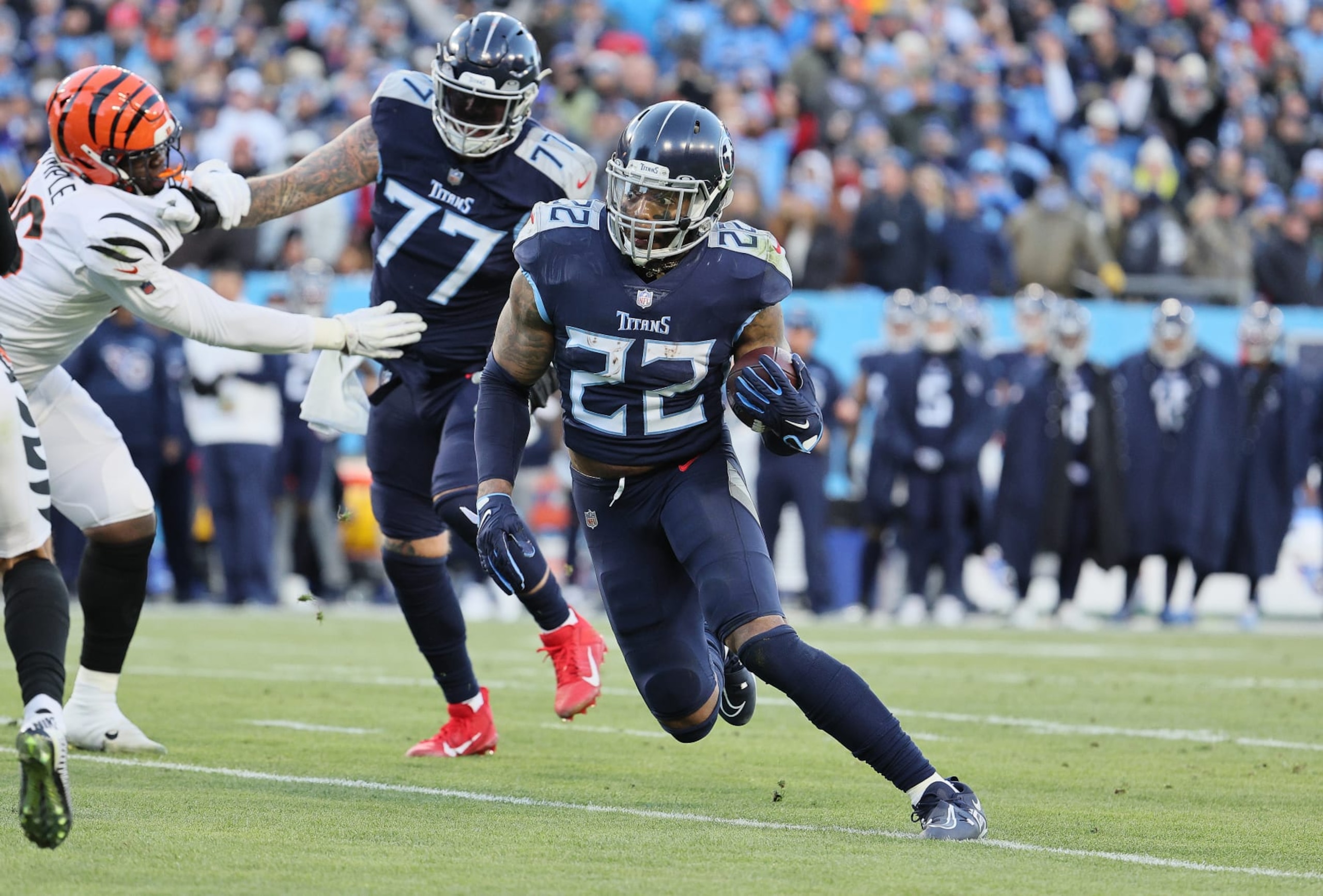 NASHVILLE, TENNESSEE - JANUARY 22: Derrick Henry #22 of the Tennessee Titans runs for a touchdown against the  Cincinnati Bengals during the AFC Divisional Playoff at Nissan Stadium on January 22, 2022 in Nashville, Tennessee. (Photo by Andy Lyons/Getty Images)