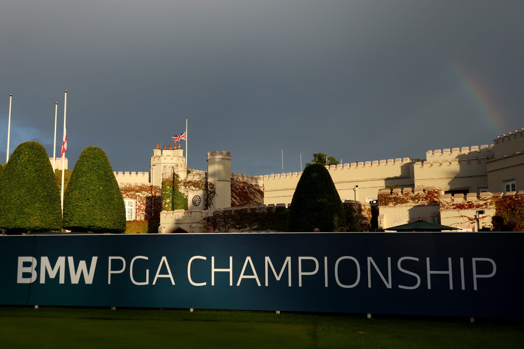 VIRGINIA WATER, ENGLAND - SEPTEMBER 08: A rainbow is seen as flags are flown at half-mast at the 1st tee following the announcement of the death of Her Majesty Queen Elizabeth II during Day One of the BMW PGA Championship at Wentworth Golf Club on September 08, 2022 in Virginia Water, England. (Photo by Andrew Redington/Getty Images)