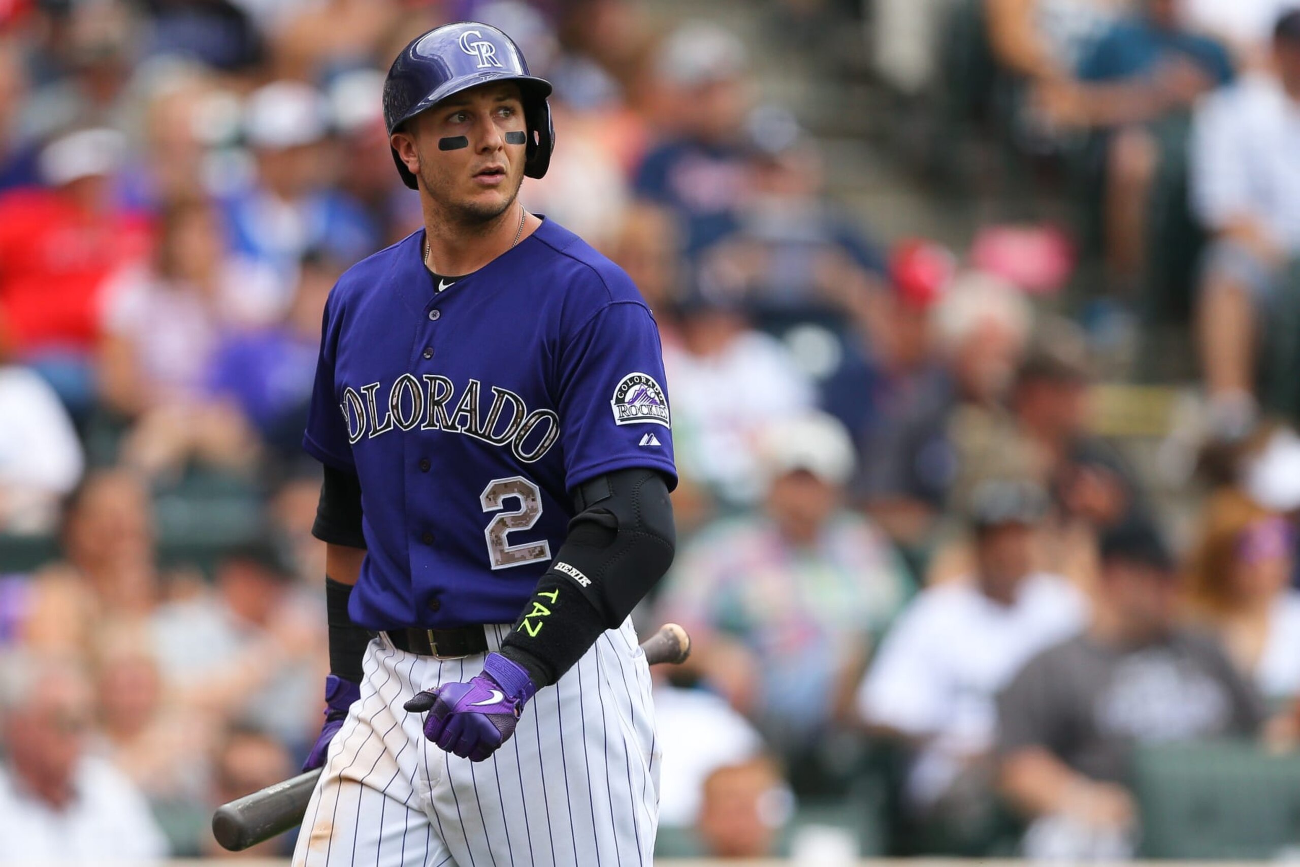 DENVER, CO - JULY 11:  Troy Tulowitzki #2 of the Colorado Rockies walks off the field after striking out during the seventh inning with a runner in scoring position against the Atlanta Braves at Coors Field on July 11, 2015 in Denver, Colorado. Tulowitzki was 0-4 at the plate on the day, ending his 21-game hit streak but did walk in the ninth to extend his on-base streak to 37 games. The Rockies defeated the Braves 3-2. (Photo by Justin Edmonds/Getty Images)