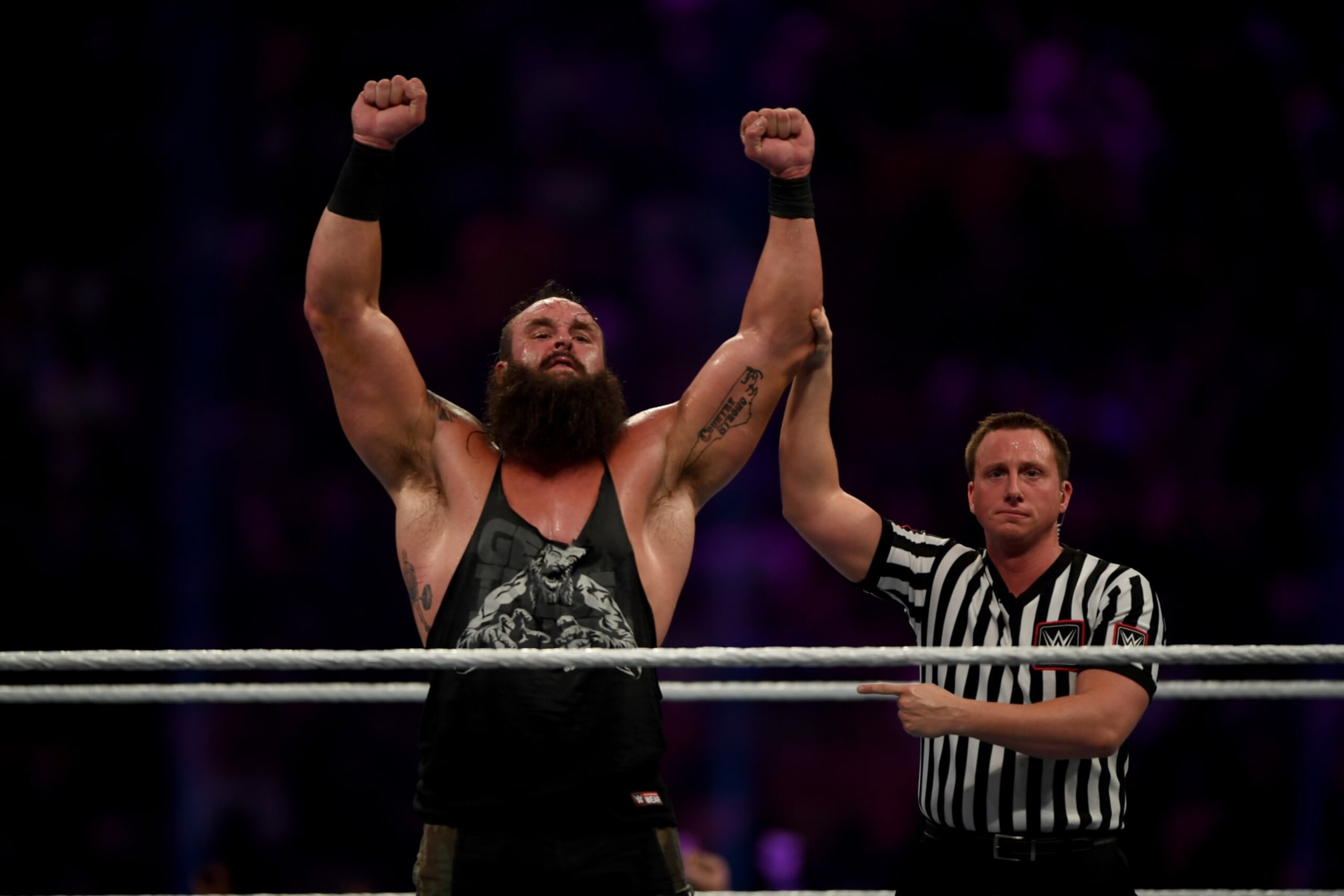 US wrestler Braun Strowman (L) raises his fists in celebration during the World Wrestling Entertainment (WWE) Super Showdown event in the Saudi Red Sea port city of Jeddah late on January 7, 2019. (Photo by Amer HILABI / AFP)        (Photo credit should read AMER HILABI/AFP via Getty Images)