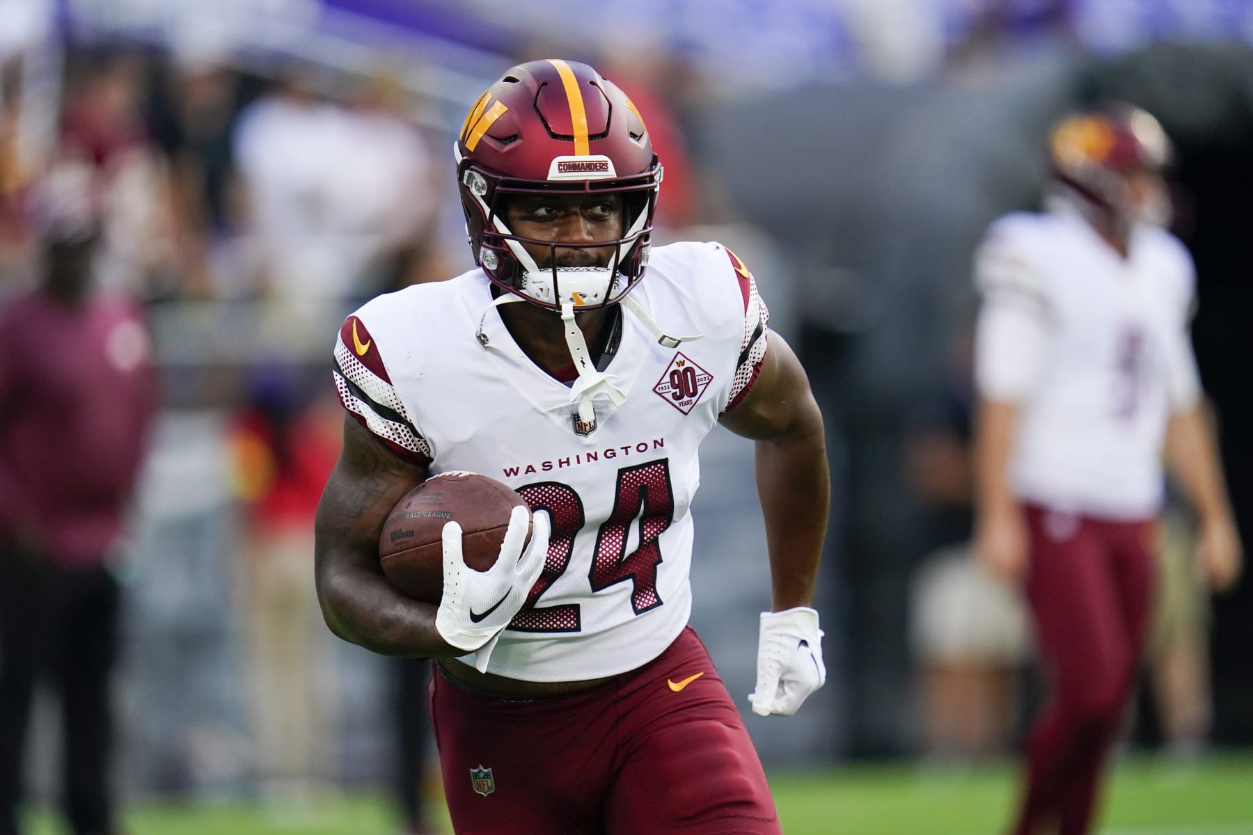 Washington Commanders running back Antonio Gibson (24) works out before a preseason NFL football game against the Baltimore Ravens, Saturday, Aug. 27, 2022, in Baltimore. (AP Photo/Julio Cortez)