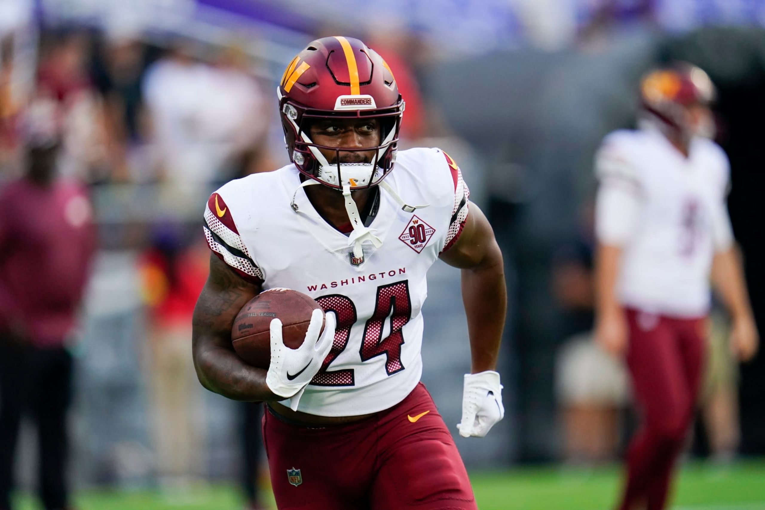 Washington Commanders running back Antonio Gibson (24) works out before a preseason NFL football game against the Baltimore Ravens, Saturday, Aug. 27, 2022, in Baltimore. (AP Photo/Julio Cortez)