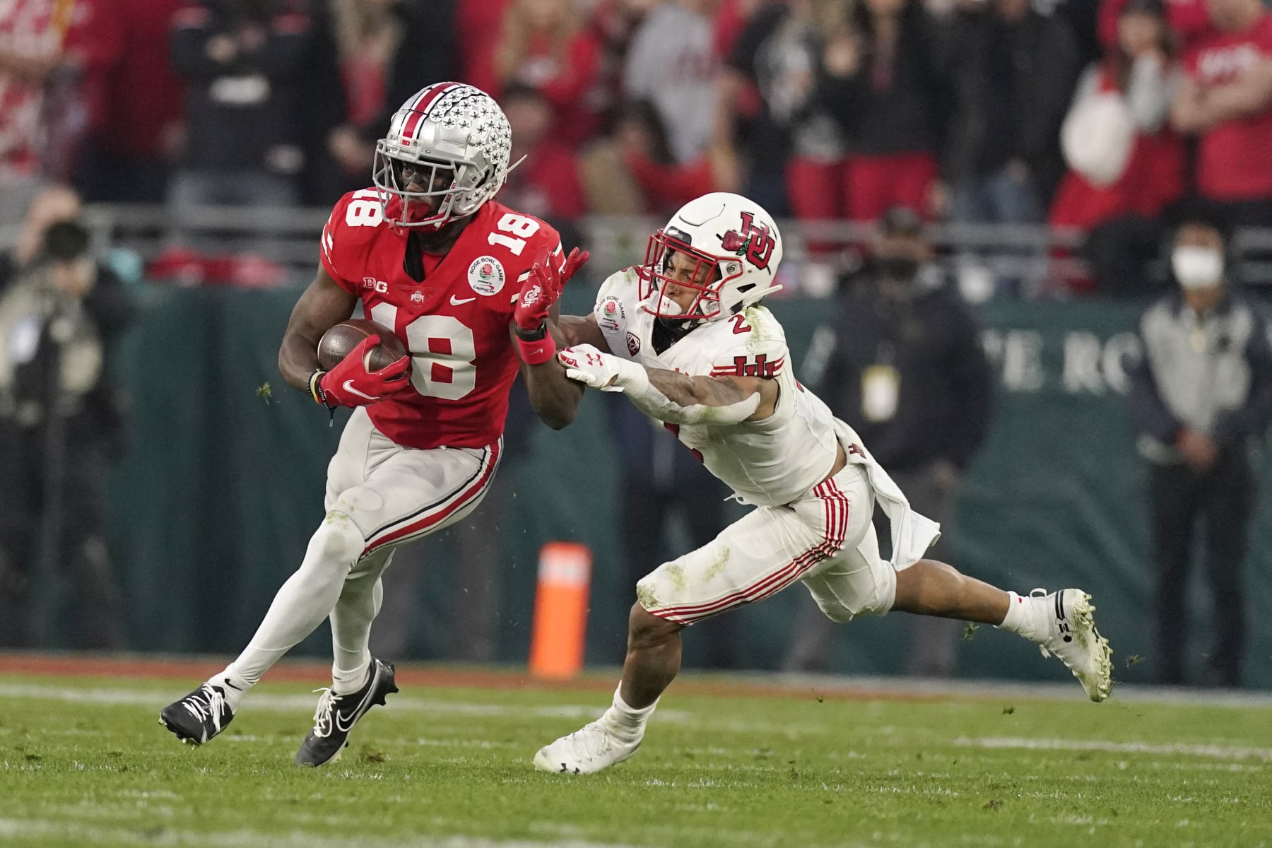 Ohio State wide receiver Marvin Harrison Jr. runs past Utah cornerback Kenzel Lawler (2) during the second half in the Rose Bowl NCAA college football game Saturday, Jan. 1, 2022, in Pasadena, Calif. (AP Photo/Mark J. Terrill)