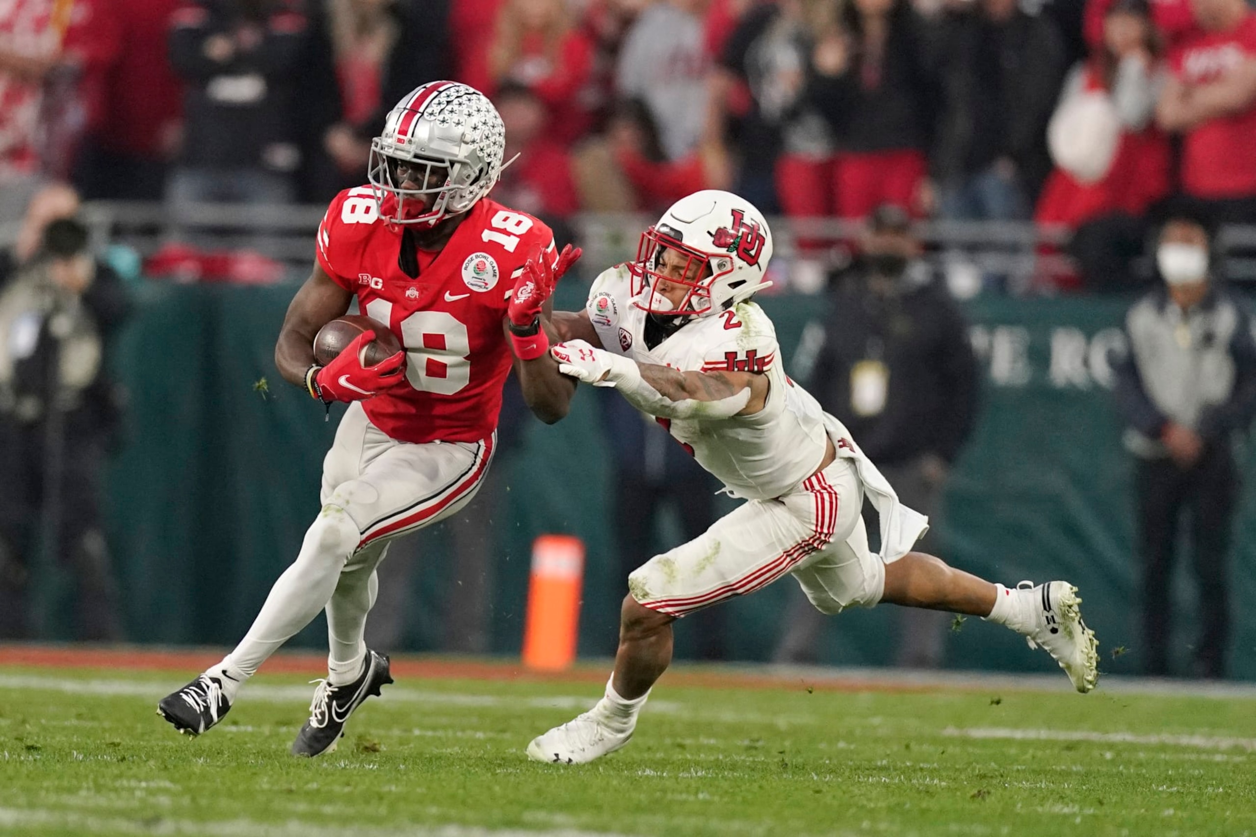 Ohio State wide receiver Marvin Harrison Jr. runs past Utah cornerback Kenzel Lawler (2) during the second half in the Rose Bowl NCAA college football game Saturday, Jan. 1, 2022, in Pasadena, Calif. (AP Photo/Mark J. Terrill)