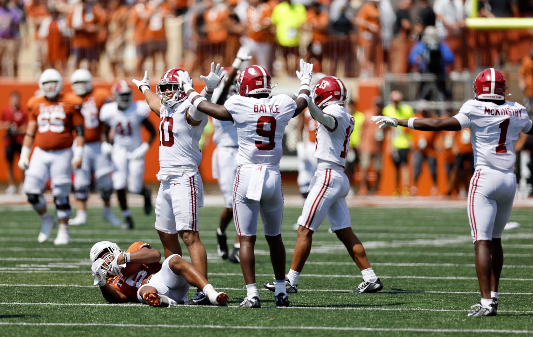 AUSTIN, TEXAS - SEPTEMBER 10: Henry To'oTo'o #10 of the Alabama Crimson Tide and Jordan Battle #9 celebrate after tackling Bijan Robinson #5 of the Texas Longhorns on the final play of the game at Darrell K Royal-Texas Memorial Stadium on September 10, 2022 in Austin, Texas. (Photo by Tim Warner/Getty Images)