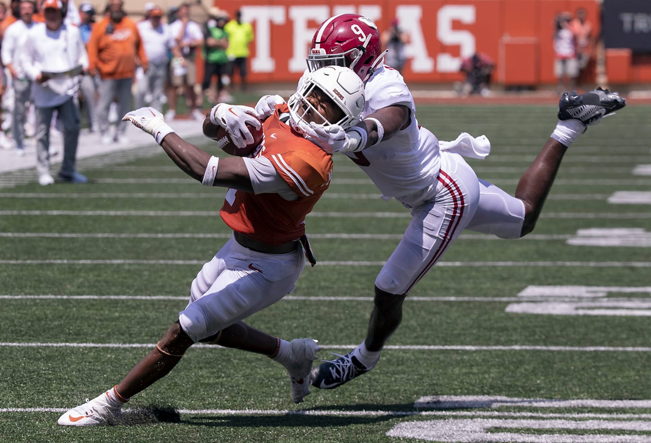 Texas running back Keilan Robinson (7) has his face mask grabbed by Alabama defensive back Jordan Battle (9) during the second half of an NCAA college football game, Saturday, Sept. 10, 2022, in Austin, Texas. Alabama defeated Texas 20-19. (AP Photo/Rodolfo Gonzalez) Texas running back Keilan Robinson (7) has his face mask grabbed by Alabama defensive back Jordan Battle (9) during the second half of an NCAA college football game, Saturday, Sept. 10, 2022, in Austin, Texas. Alabama defeated Texas 20-19. (AP Photo/Rodolfo Gonzalez)