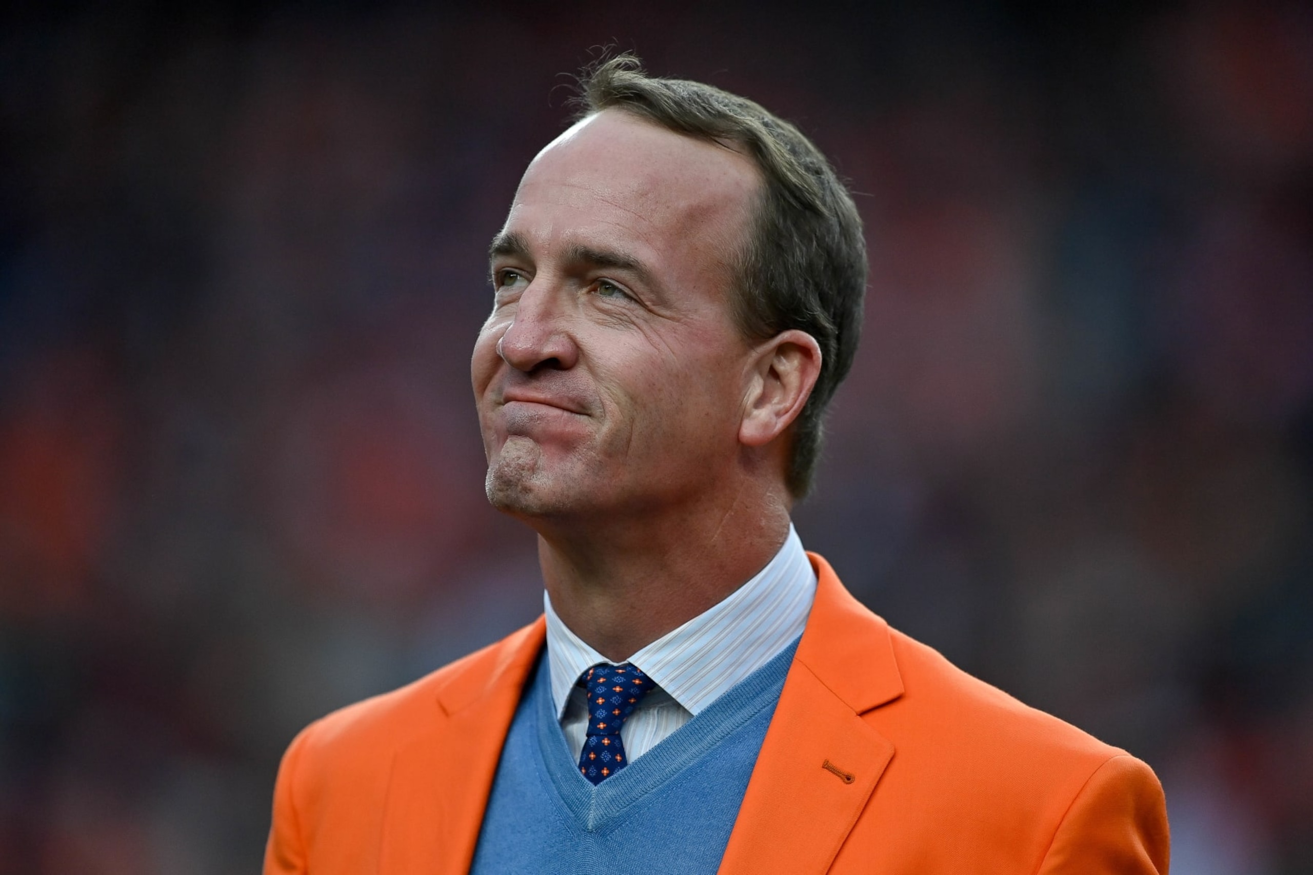 DENVER, CO - OCTOBER 31: Former Denver Broncos quarterback Peyton Manning looks on during a ceremony to reveal his name on the stadium Ring of Fame at halftime during a game between the Denver Broncos and the Washington Football Team at Empower Field at Mile High on October 31, 2021 in Denver, Colorado. (Photo by Dustin Bradford/Icon Sportswire via Getty Images)