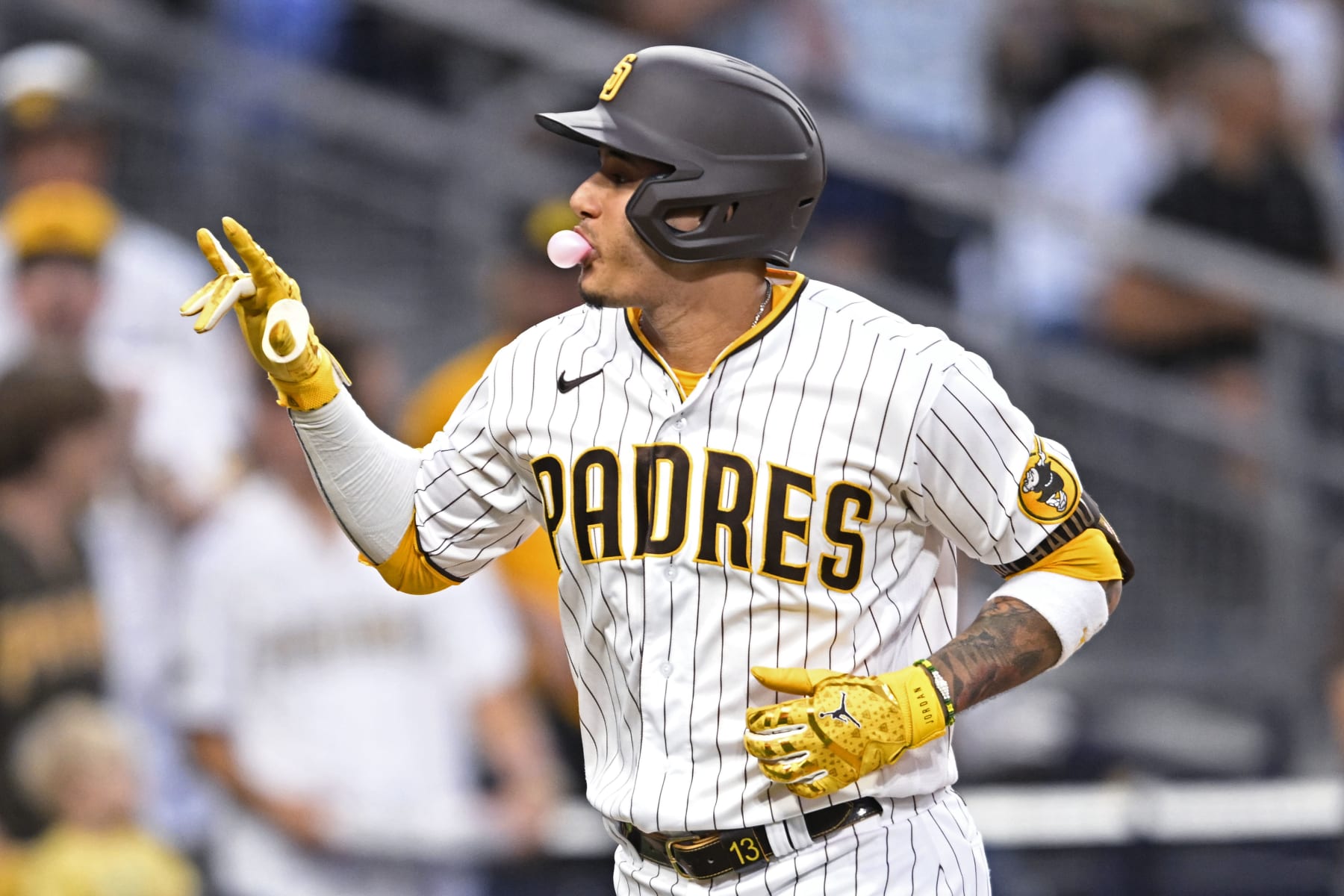 SAN DIEGO, CA - SEPTEMBER 10: Manny Machado #13 of the San Diego Padres blows a bubble after hitting a solo home run during the third inning of a baseball game against the Los Angeles Dodgers September 10, 2022 at Petco Park in San Diego, California. (Photo by Denis Poroy/Getty Images)