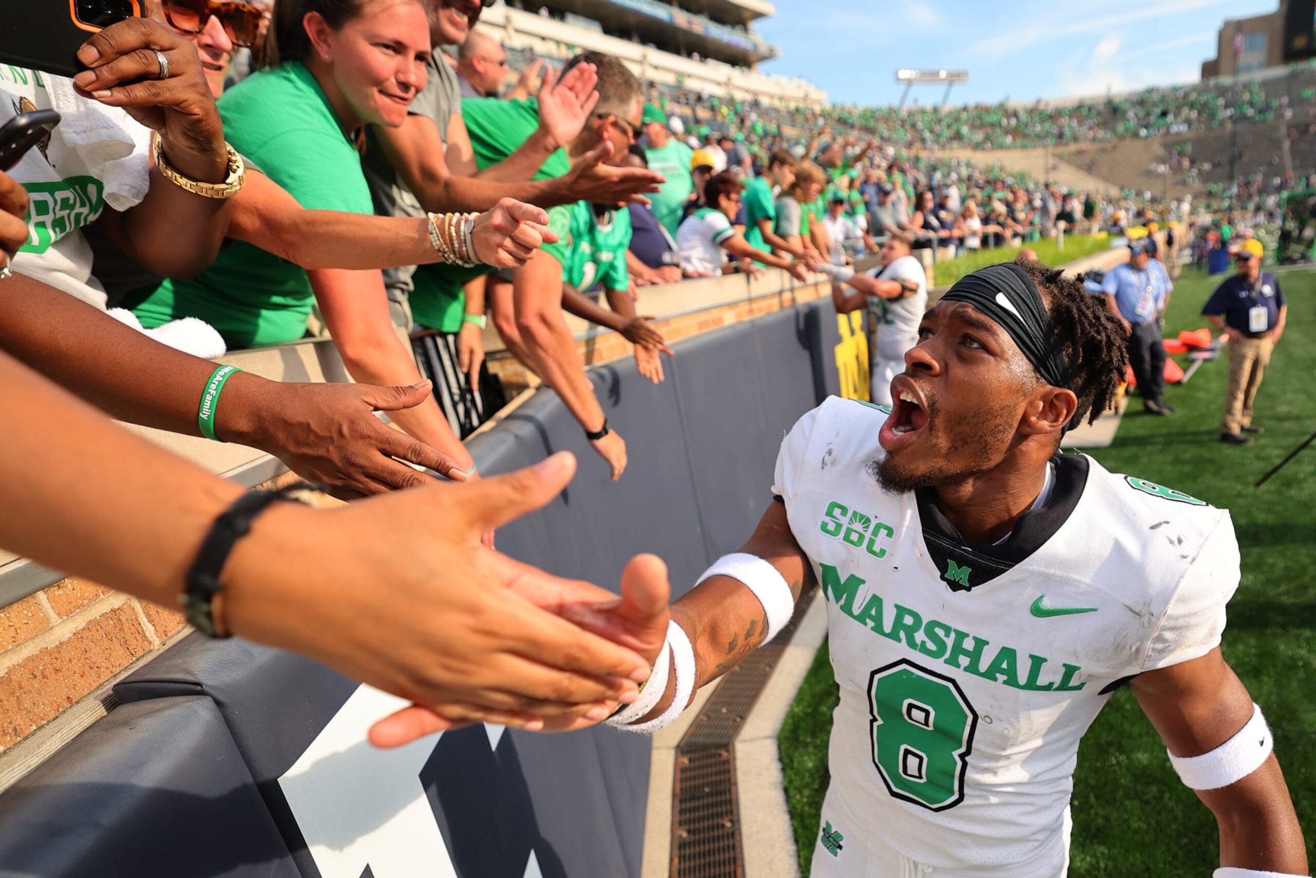 SOUTH BEND, INDIANA - SEPTEMBER 10: Isaiah Norman #8 of the Marshall Thundering Herd high fives fans after defeating the Notre Dame Fighting Irish 26-21 at Notre Dame Stadium on September 10, 2022 in South Bend, Indiana. (Photo by Michael Reaves/Getty Images)