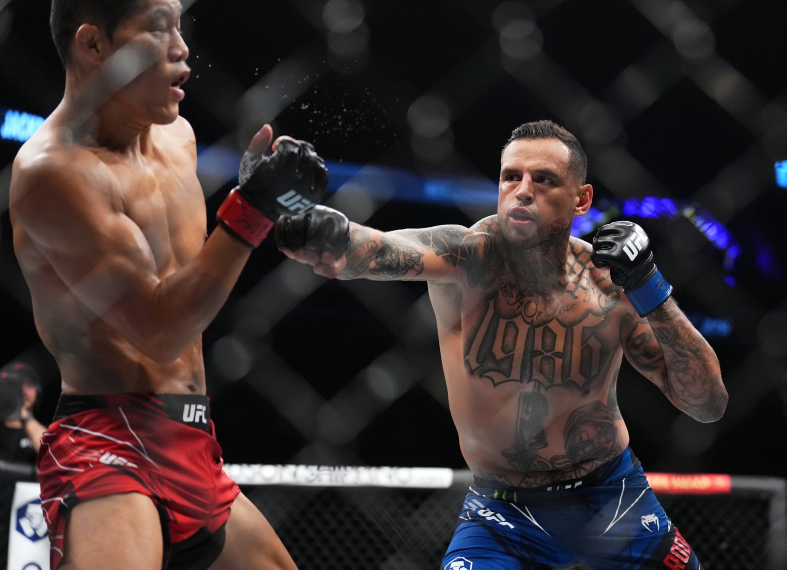 LAS VEGAS, NEVADA - SEPTEMBER 10: (R-L) Daniel Rodriguez punches Li Jingliang of China in a 180-pound catchweight fight during the UFC 279 event at T-Mobile Arena on September 10, 2022 in Las Vegas, Nevada. (Photo by Chris Unger/Zuffa LLC) LAS VEGAS, NEVADA - SEPTEMBER 10: (R-L) Daniel Rodriguez punches Li Jingliang of China in a 180-pound catchweight fight during the UFC 279 event at T-Mobile Arena on September 10, 2022 in Las Vegas, Nevada. (Photo by Chris Unger/Zuffa LLC)