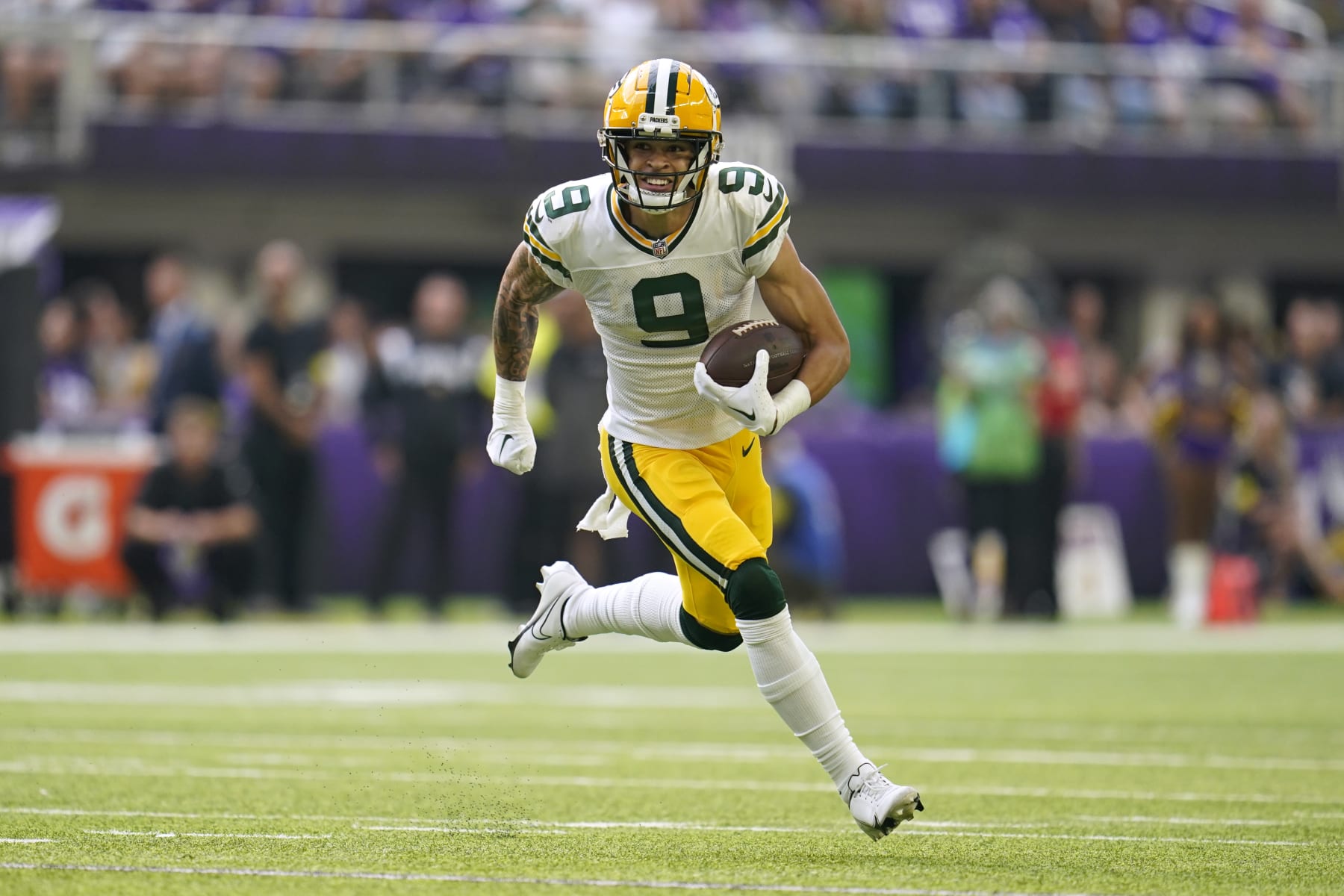 Green Bay Packers wide receiver Christian Watson (9) runs up field after catching a pass during the first half of an NFL football game against the Minnesota Vikings, Sunday, Sept. 11, 2022, in Minneapolis. (AP Photo/Abbie Parr)