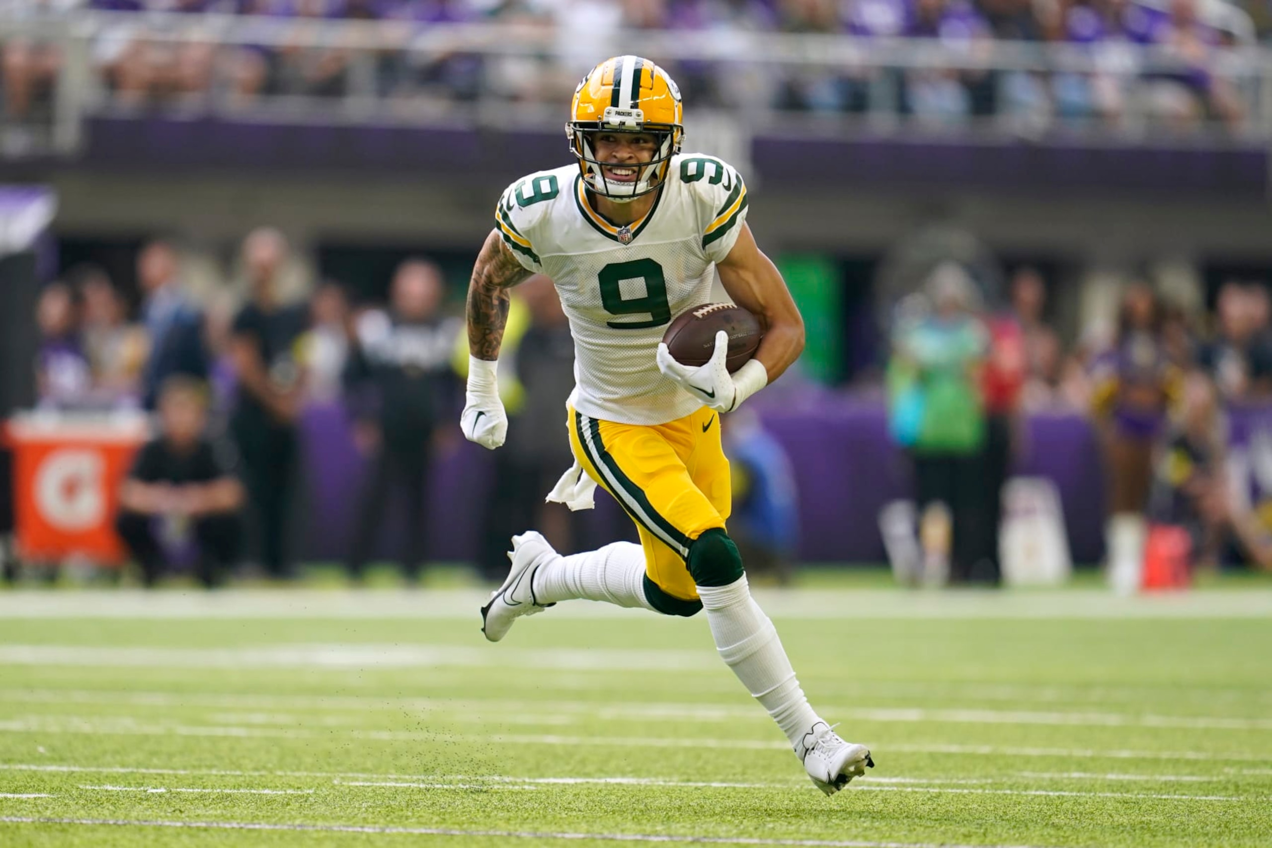 Green Bay Packers wide receiver Christian Watson (9) runs up field after catching a pass during the first half of an NFL football game against the Minnesota Vikings, Sunday, Sept. 11, 2022, in Minneapolis. (AP Photo/Abbie Parr)