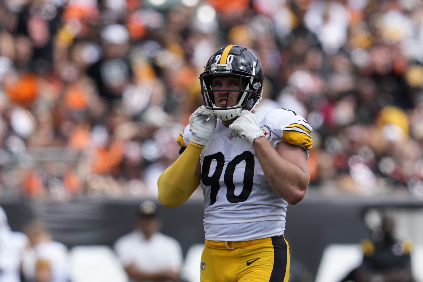 Pittsburgh Steelers linebacker T.J. Watt (90) adjust his chin strap during the second half of an NFL football game against the Cincinnati Bengals, Sunday, Sept. 11, 2022, in Cincinnati. (AP Photo/Jeff Dean)