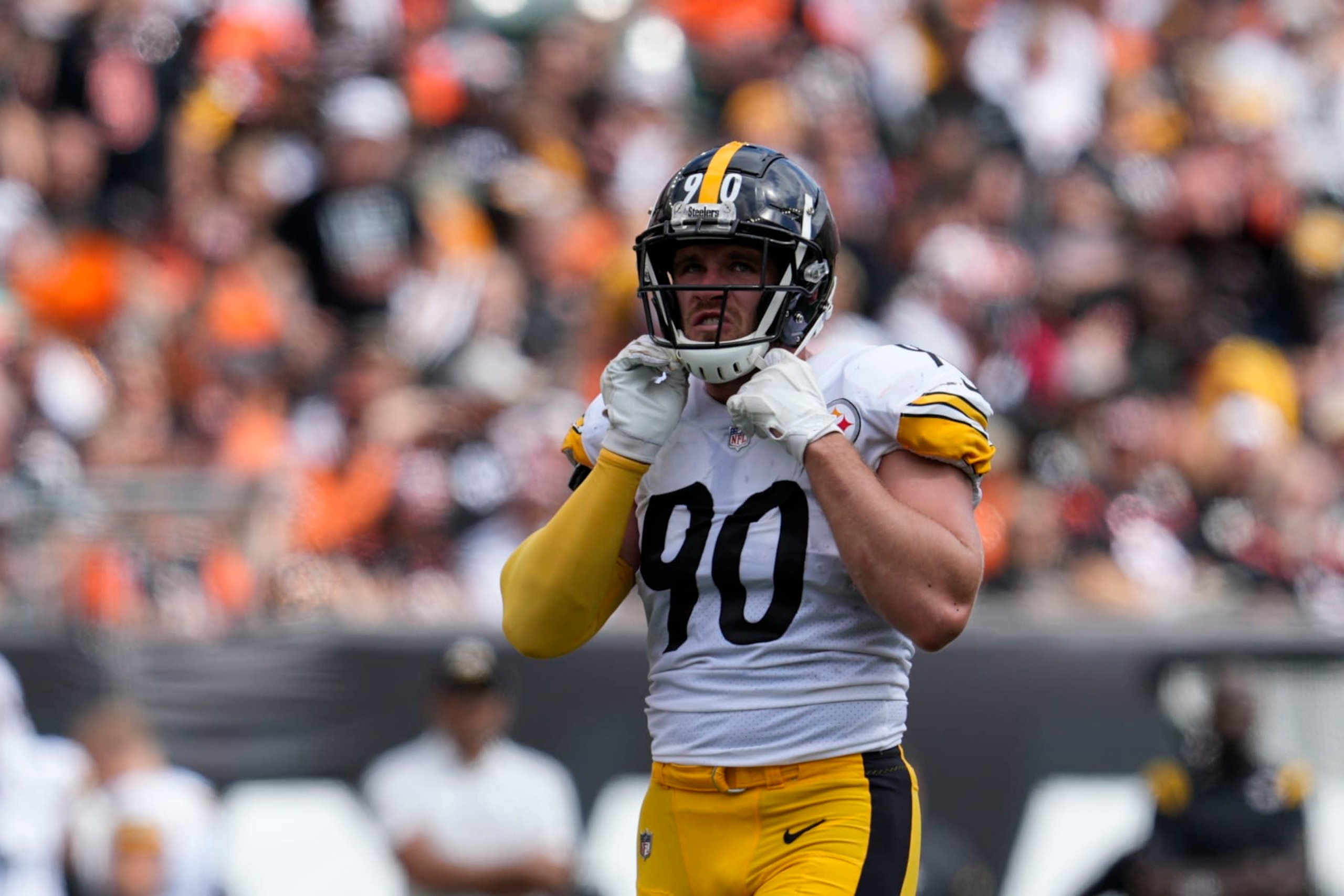 Pittsburgh Steelers linebacker T.J. Watt (90) adjust his chin strap during the second half of an NFL football game against the Cincinnati Bengals, Sunday, Sept. 11, 2022, in Cincinnati. (AP Photo/Jeff Dean)