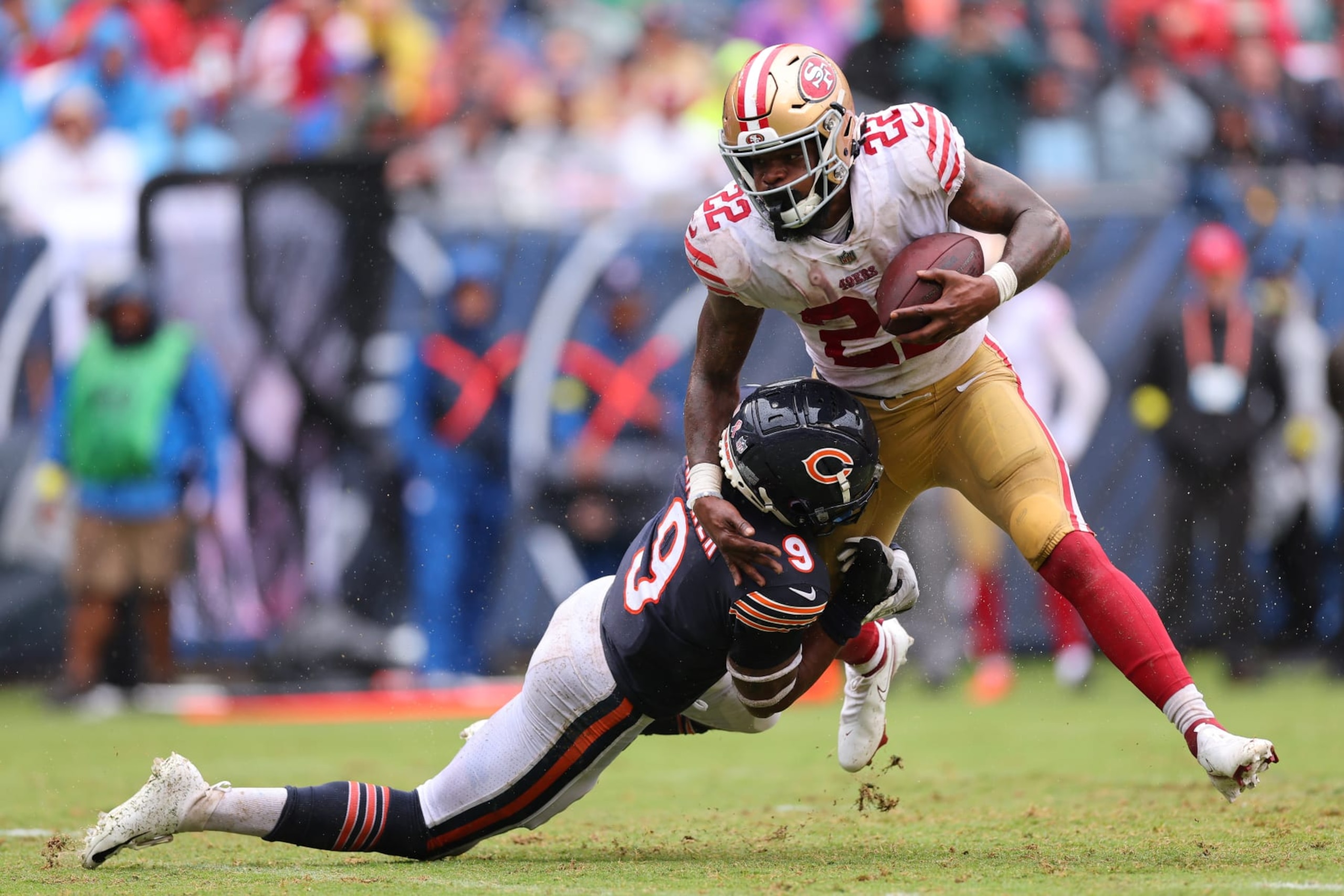 CHICAGO, ILLINOIS - SEPTEMBER 11: Safety Jaquan Brisker #9 of the Chicago Bears tackles running back Jeff Wilson Jr. #22 of the San Francisco 49ers during the second half at Soldier Field on September 11, 2022 in Chicago, Illinois. (Photo by Michael Reaves/Getty Images)