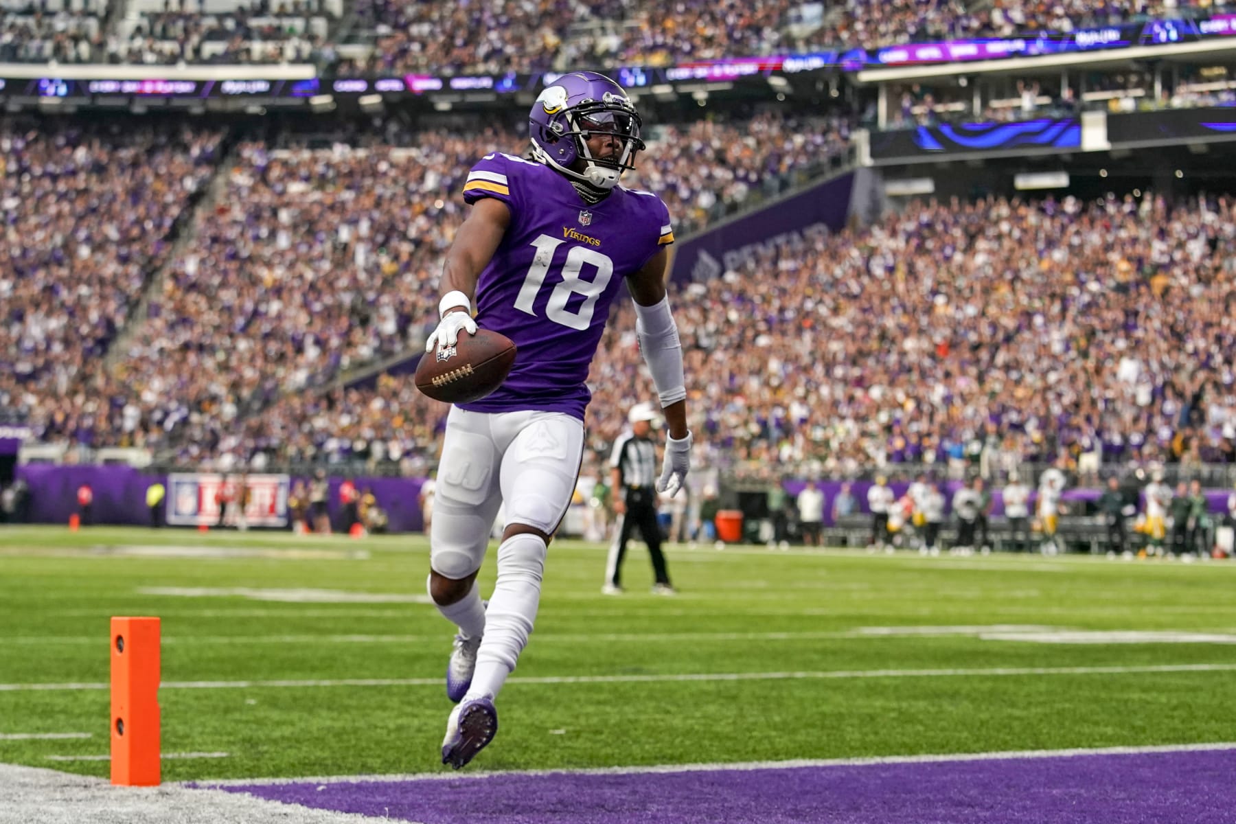 MINNEAPOLIS, MN - SEPTEMBER 11: Minnesota Vikings wide receiver Justin Jefferson (18) crosses the goal line for a touchdown after catching a 5-yard pass from Minnesota Vikings quarterback Kirk Cousins (8) during the first quarter of an NFL game between the Minnesota Vikings and Green Bay Packers on September 11, 2022 at U.S. Bank Stadium in Minneapolis, MN.(Photo by Nick Wosika/Icon Sportswire via Getty Images)