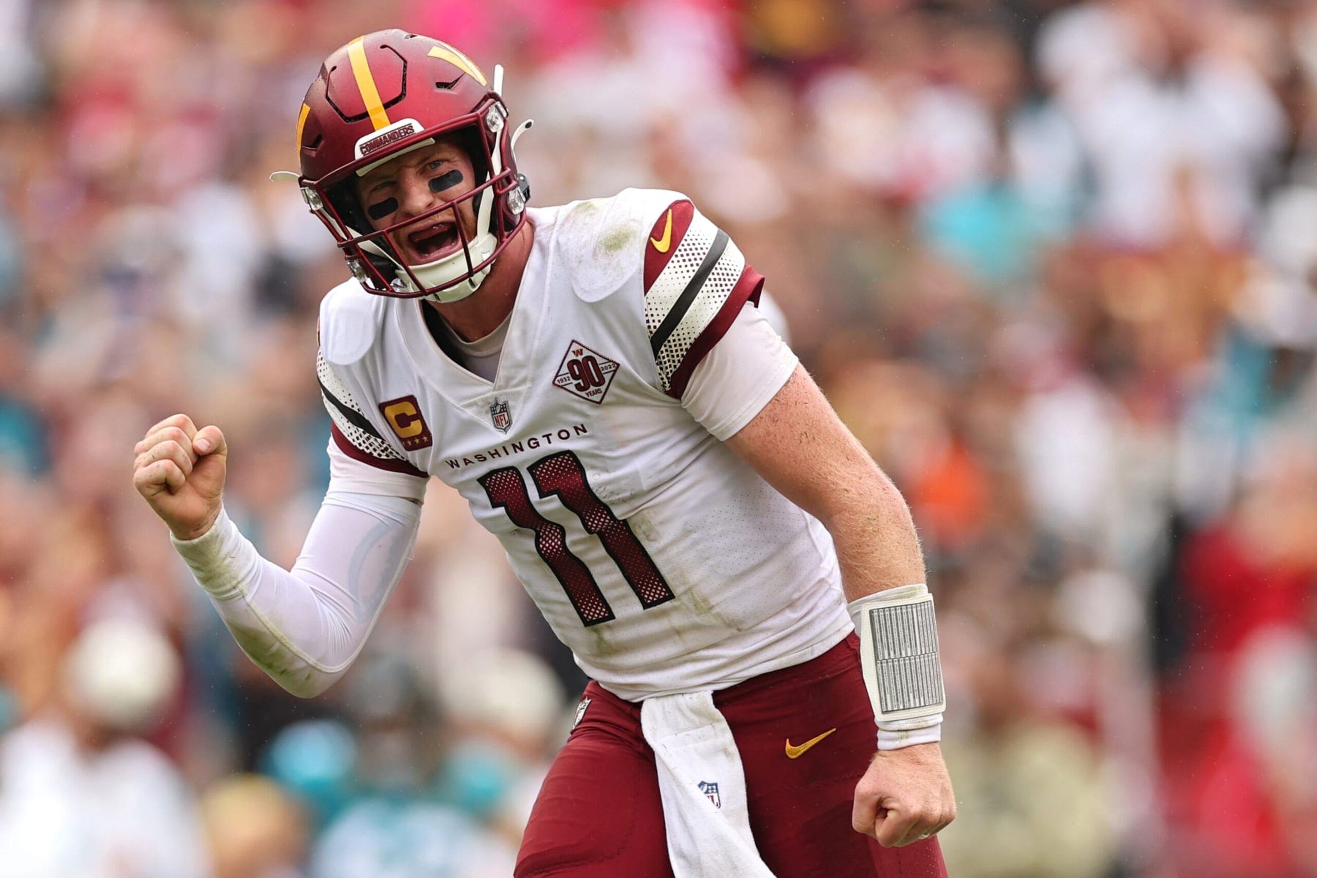 LANDOVER, MARYLAND - SEPTEMBER 11: Quarterback Carson Wentz #11 of the Washington Commanders celebrates after throwing a touchdown pass to wide receiver Jahan Dotson #1 against the Jacksonville Jaguars during the second quarter FedExField on September 11, 2022 in Landover, Maryland. (Photo by Patrick Smith/Getty Images)