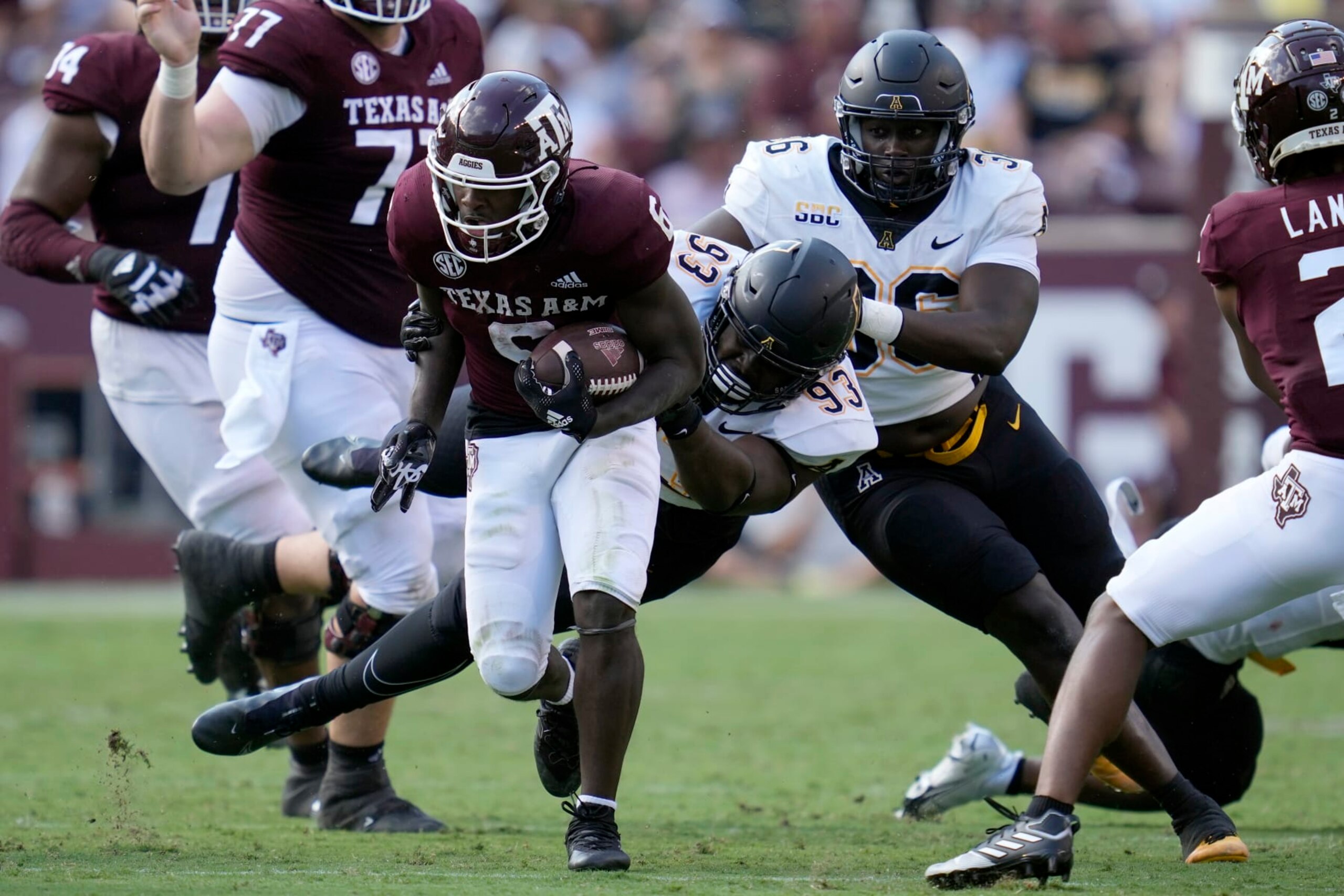 Appalachian State defensive lineman KaRon White (93) brings down Texas A&M running back Devon Achane (6) after a short gain during the second half of an NCAA college football game Saturday, Sept. 10, 2022, in College Station, Texas. (AP Photo/Sam Craft)