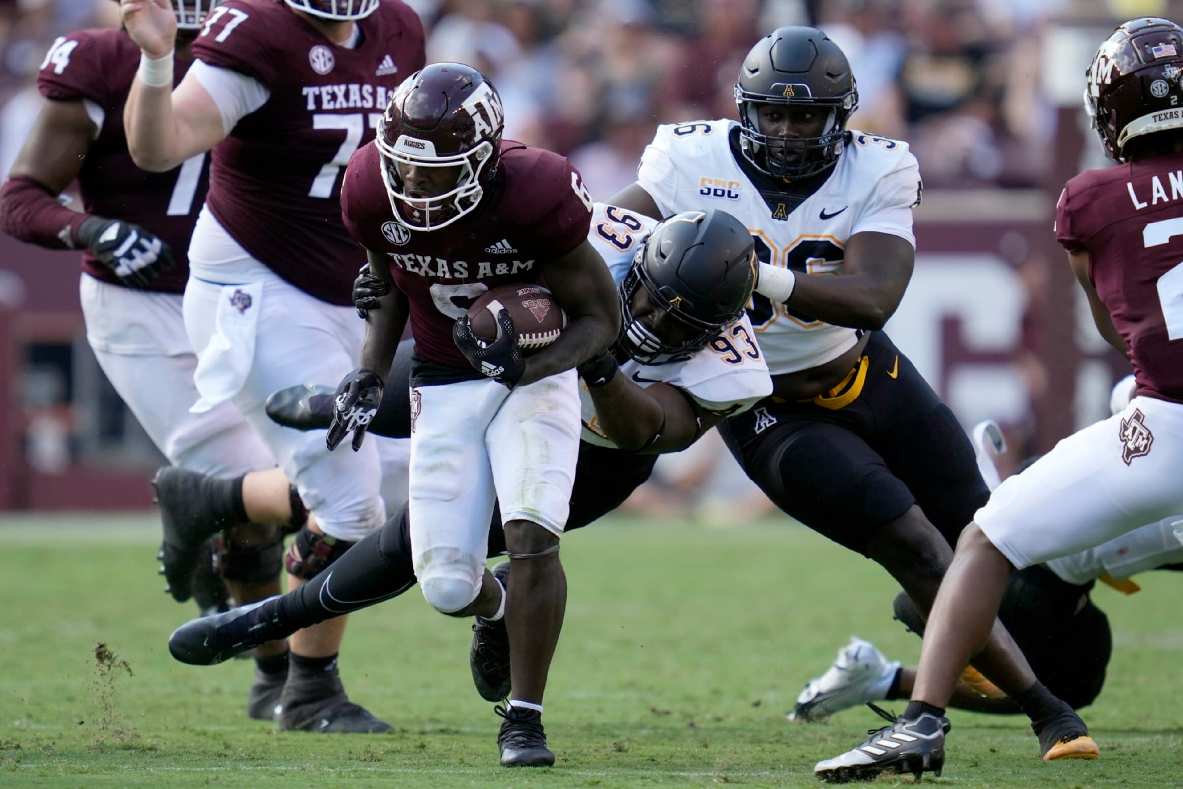 Appalachian State defensive lineman KaRon White (93) brings down Texas A&M running back Devon Achane (6) after a short gain during the second half of an NCAA college football game Saturday, Sept. 10, 2022, in College Station, Texas. (AP Photo/Sam Craft)