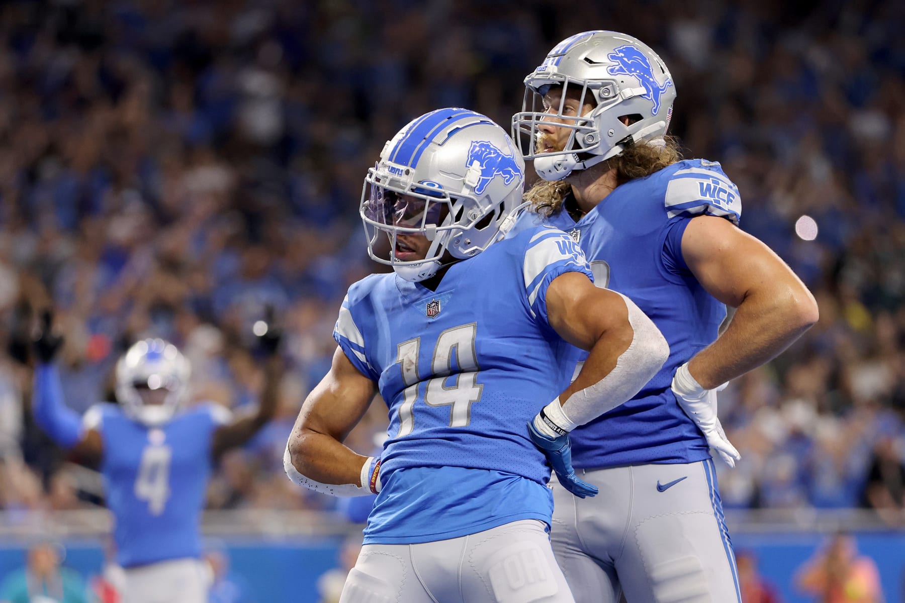 DETROIT, MICHIGAN - SEPTEMBER 11: Wide Receiver Amon-Ra St. Brown #14 of the Detroit Lions & Tight End T.J. Hockenson #88 of the Detroit Lions celebrate a touchdown in the end zone during the third quarter of the game at Ford Field on September 11, 2022 in Detroit, Michigan. (Photo by Gregory Shamus/Getty Images)
