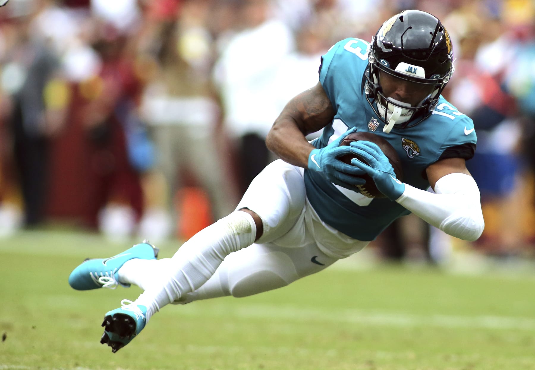 Jacksonville Jaguars wide receiver Christian Kirk (13) makes a catch during an NFL football game against the Washington Commanders, Sunday, Sept. 11, 2022 in Landover. (AP Photo/Daniel Kucin Jr.)