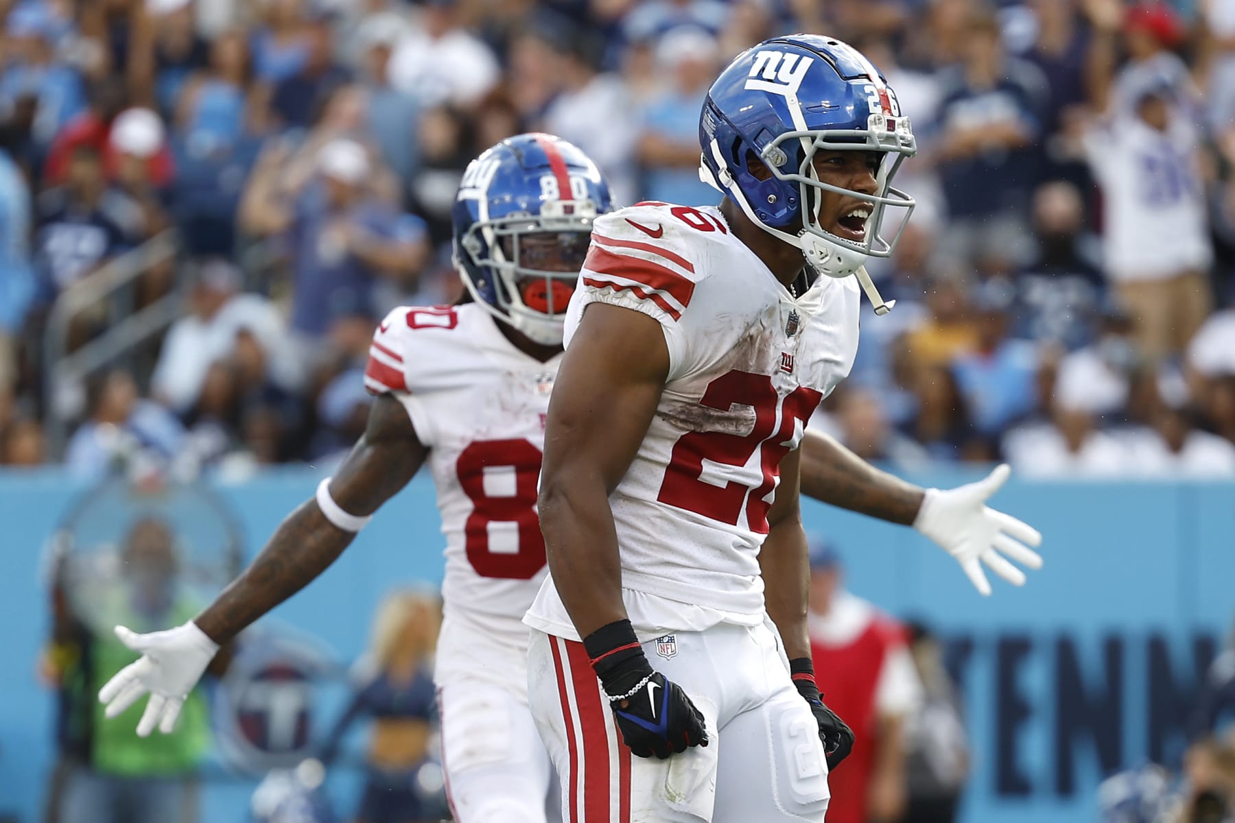 NASHVILLE, TENNESSEE - SEPTEMBER 11: Running back Saquon Barkley #26 of the New York Giants celebrates after scoring a touchdown during the third quarter against the Tennessee Titans at Nissan Stadium on September 11, 2022 in Nashville, Tennessee. (Photo by Wesley Hitt/Getty Images)