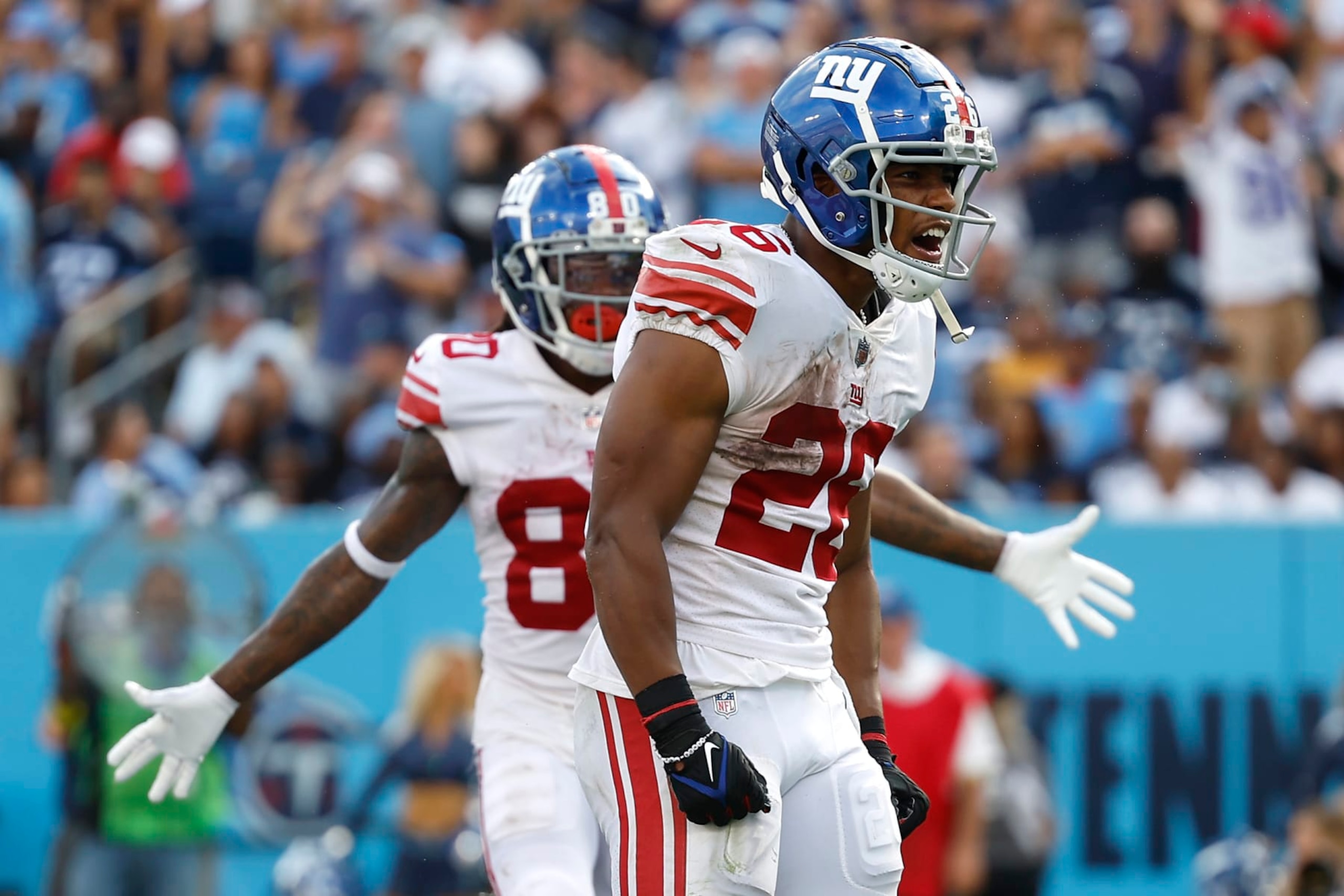 NASHVILLE, TENNESSEE - SEPTEMBER 11: Running back Saquon Barkley #26 of the New York Giants celebrates after scoring a touchdown during the third quarter against the Tennessee Titans at Nissan Stadium on September 11, 2022 in Nashville, Tennessee. (Photo by Wesley Hitt/Getty Images)