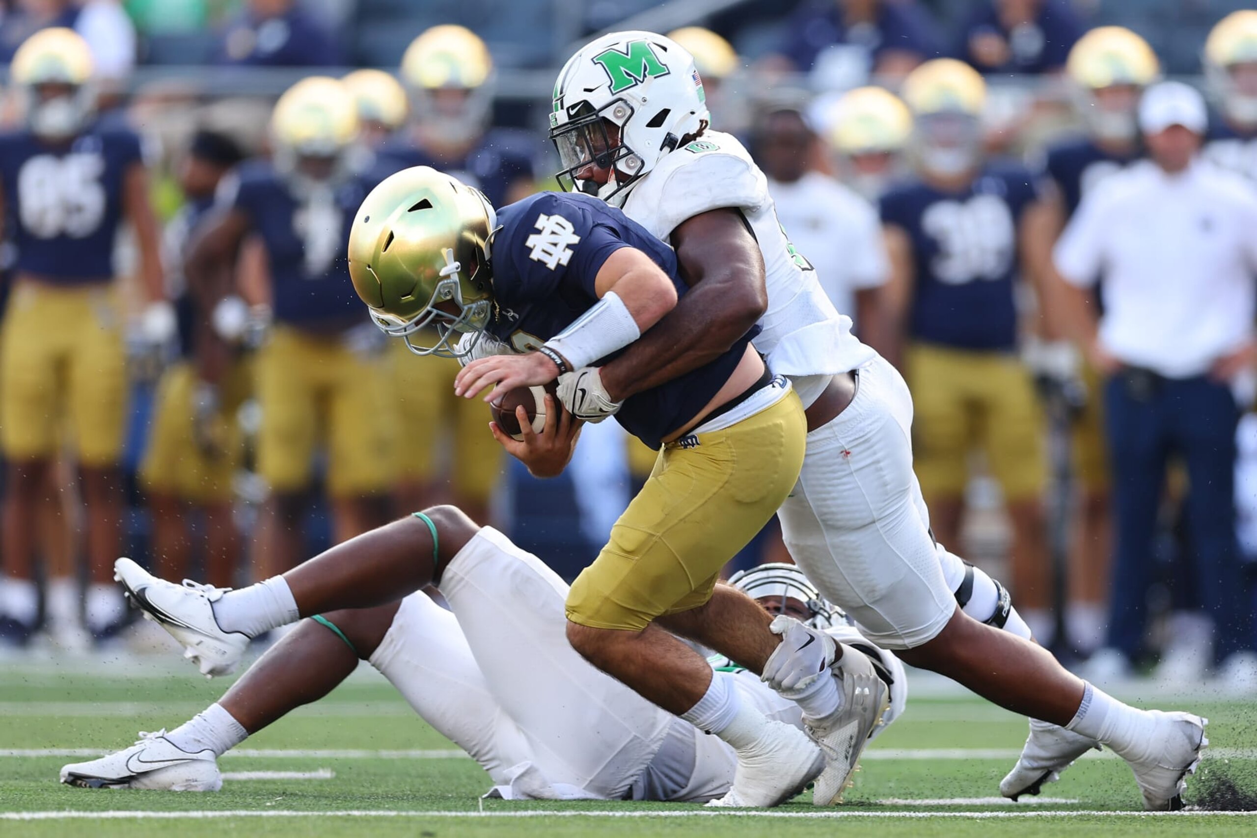 SOUTH BEND, INDIANA - SEPTEMBER 10: Sam Burton #0 of the Marshall Thundering Herd sacks Drew Pyne #10 of the Notre Dame Fighting Irish during the second half at Notre Dame Stadium on September 10, 2022 in South Bend, Indiana. (Photo by Michael Reaves/Getty Images)