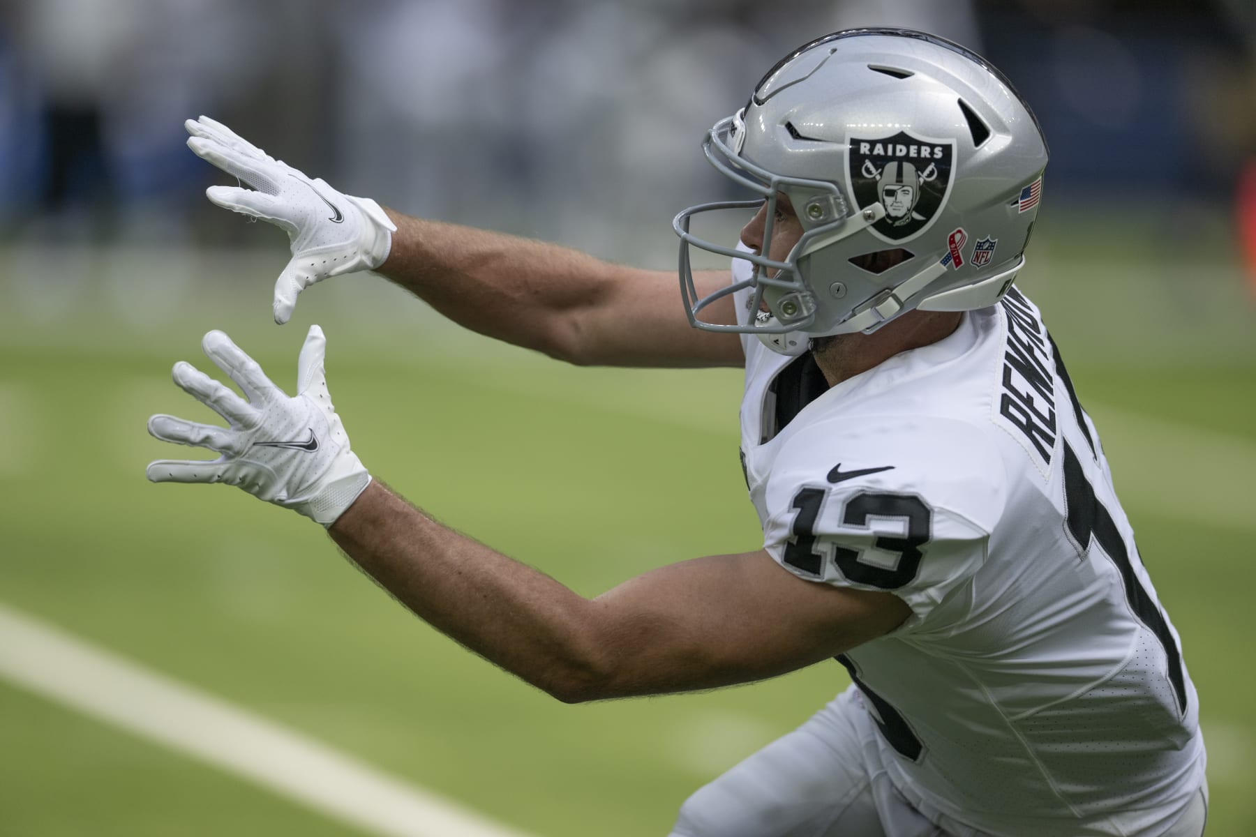 Las Vegas Raiders wide receiver Hunter Renfrow (13) reaches for a pass while playing the Los Angeles Chargers during an NFL Football Game Sunday, Sept. 11, 2022, in Inglewood, Calif. (AP Photo/John McCoy)
