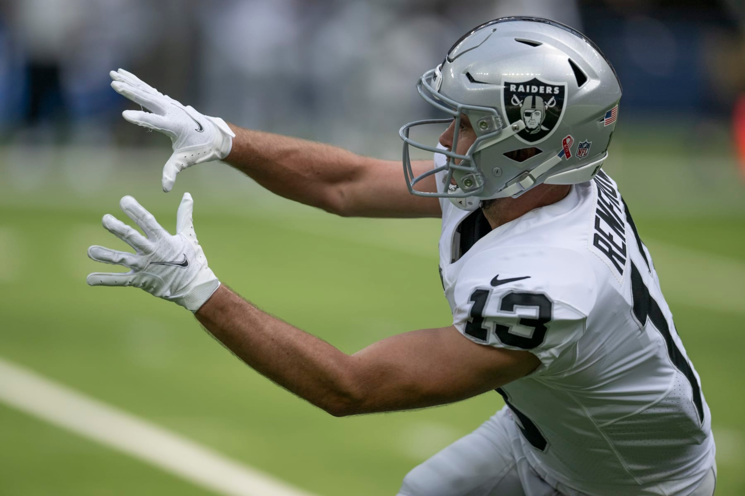 Las Vegas Raiders wide receiver Hunter Renfrow (13) reaches for a pass while playing the Los Angeles Chargers during an NFL Football Game Sunday, Sept. 11, 2022, in Inglewood, Calif. (AP Photo/John McCoy)