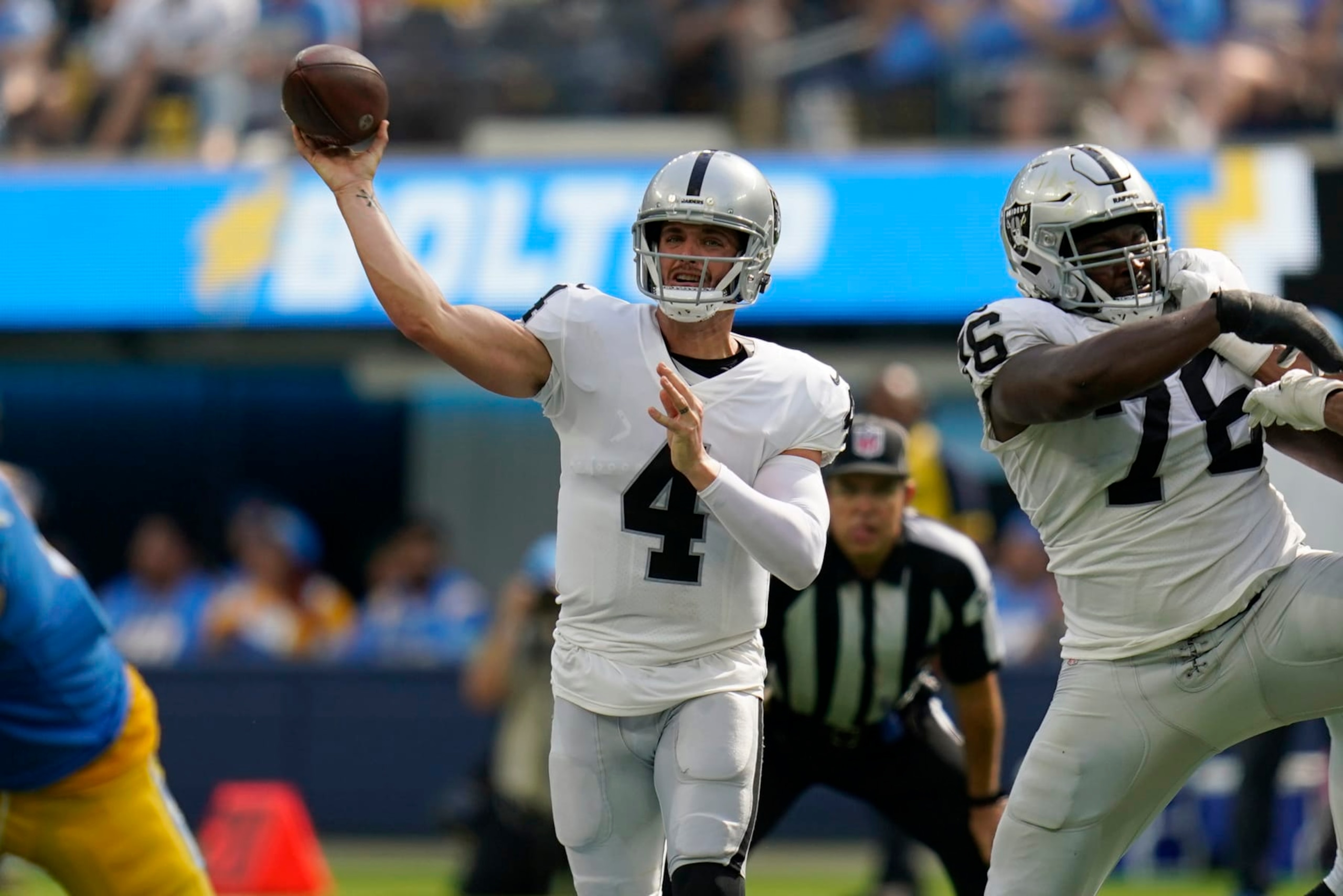 Las Vegas Raiders quarterback Derek Carr (4) passes against the Los Angeles Chargers during an NFL football game in Inglewood, Calif., Sunday, Sept. 11, 2022. (AP Photo/Gregory Bull)