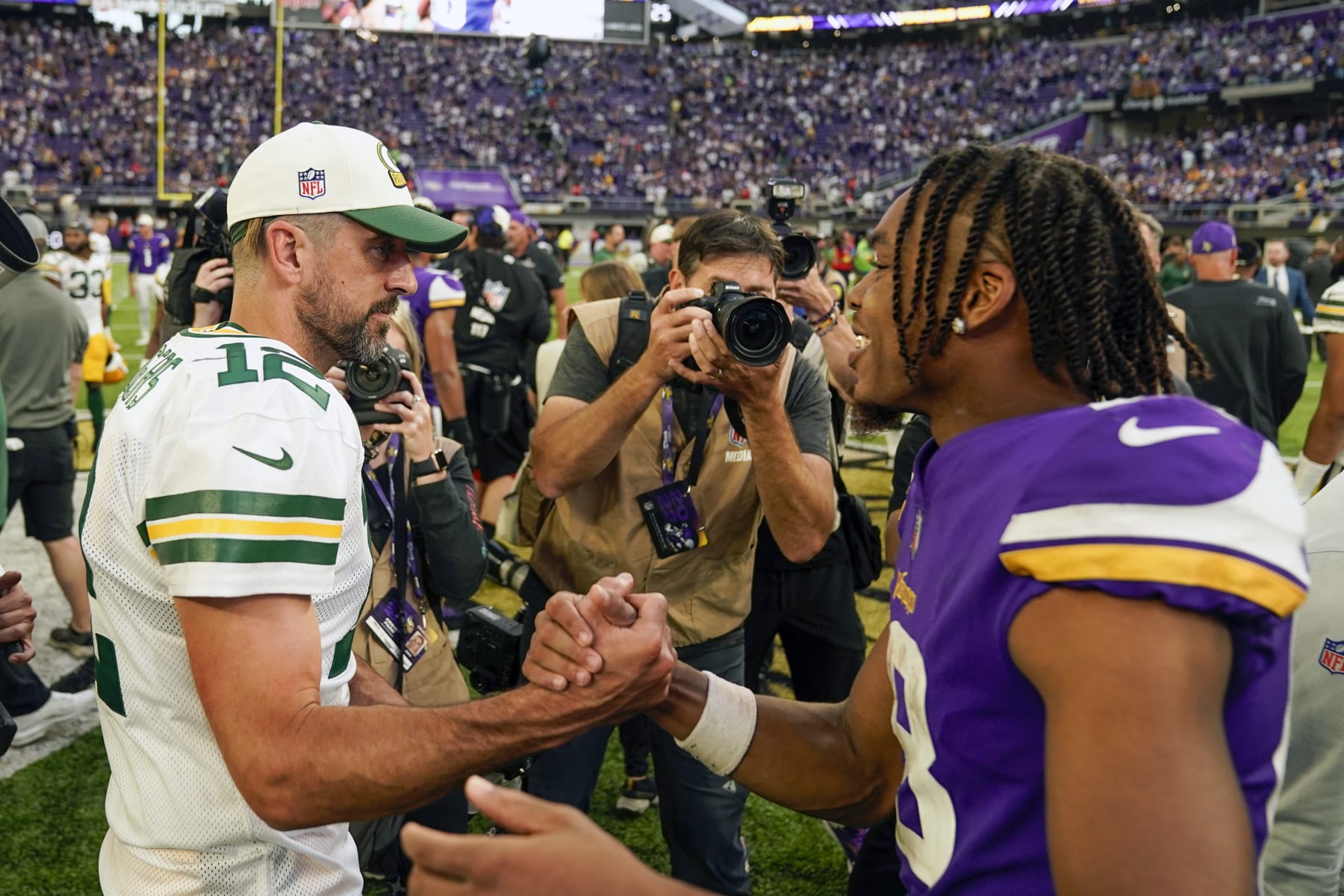 MINNEAPOLIS, MN - SEPTEMBER 11: Green Bay Packers quarterback Aaron Rodgers (12) and Minnesota Vikings wide receiver Justin Jefferson (18) chat after an NFL game between the Minnesota Vikings and Green Bay Packers on September 11, 2022 at U.S. Bank Stadium in Minneapolis, MN.(Photo by Nick Wosika/Icon Sportswire via Getty Images)