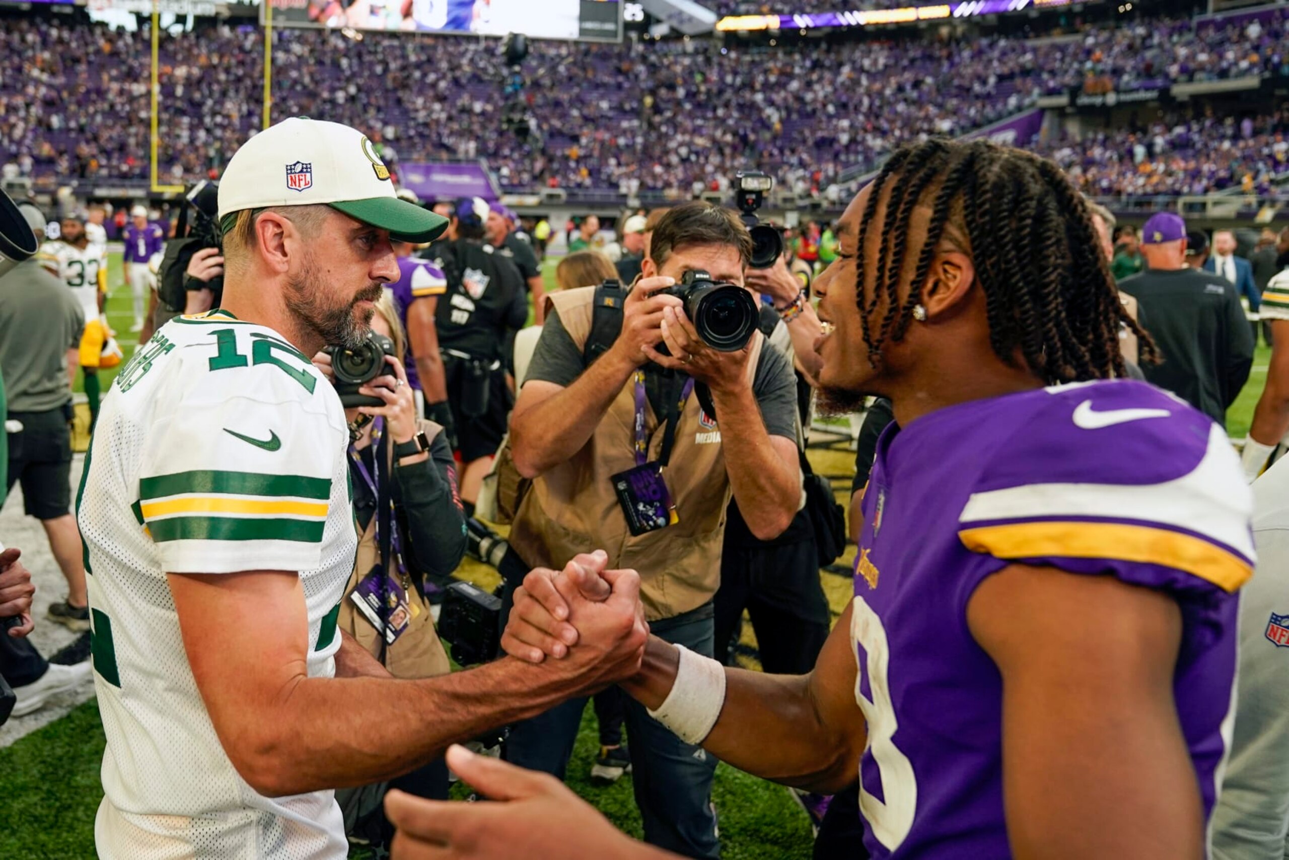 MINNEAPOLIS, MN - SEPTEMBER 11: Green Bay Packers quarterback Aaron Rodgers (12) and Minnesota Vikings wide receiver Justin Jefferson (18) chat after an NFL game between the Minnesota Vikings and Green Bay Packers on September 11, 2022 at U.S. Bank Stadium in Minneapolis, MN.(Photo by Nick Wosika/Icon Sportswire via Getty Images)
