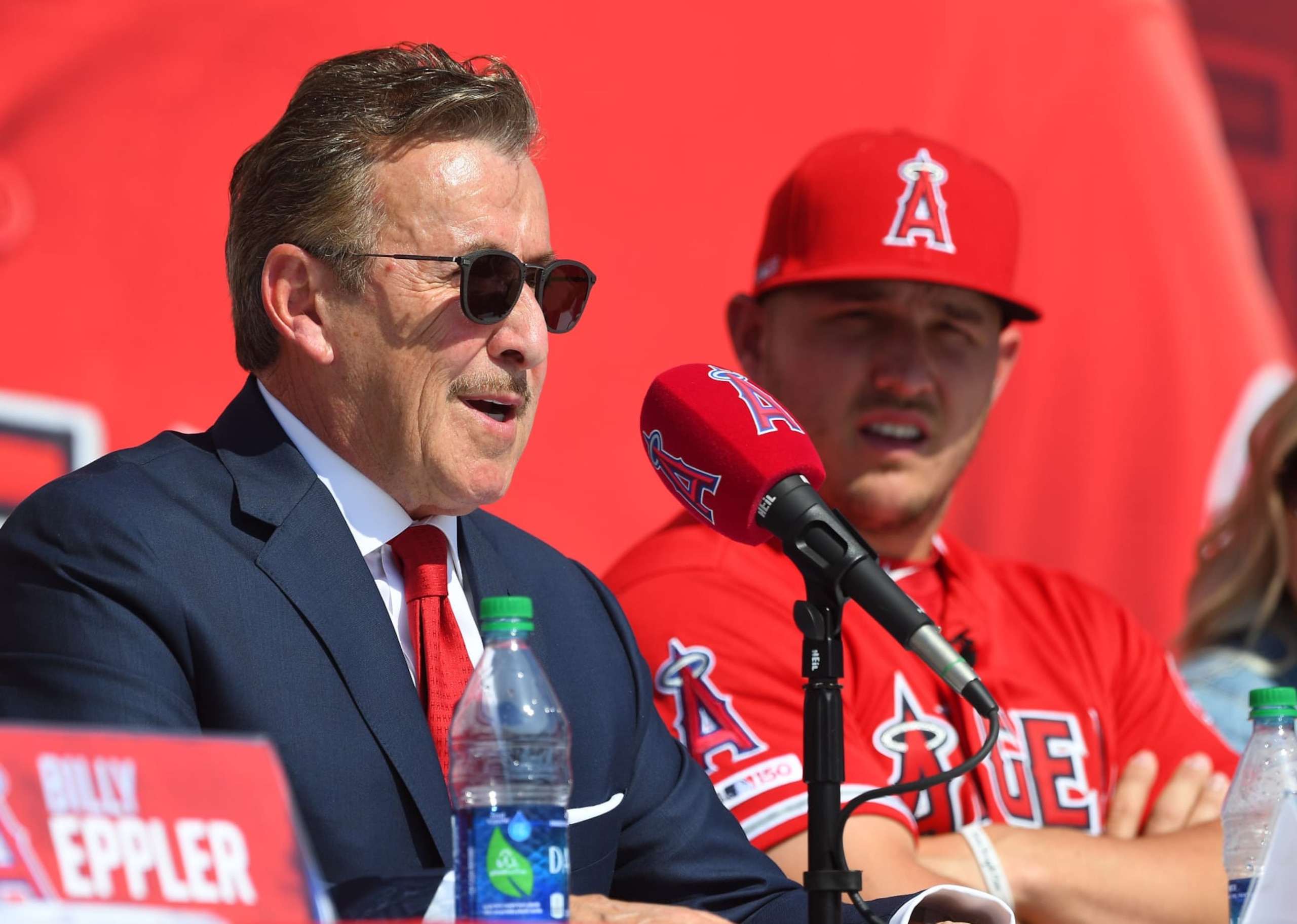 ANAHEIM, CA - MARCH 24: Mike Trout #27 of the Los Angeles Angels of Anaheim looks on as owner Arte Moreno talks during a press conference at Angel Stadium of Anaheim on March 24, 2019 in Anaheim, California. (Photo by Jayne Kamin-Oncea/Getty Images) ANAHEIM, CA - MARCH 24: Mike Trout #27 of the Los Angeles Angels of Anaheim looks on as owner Arte Moreno talks during a press conference at Angel Stadium of Anaheim on March 24, 2019 in Anaheim, California. (Photo by Jayne Kamin-Oncea/Getty Images)