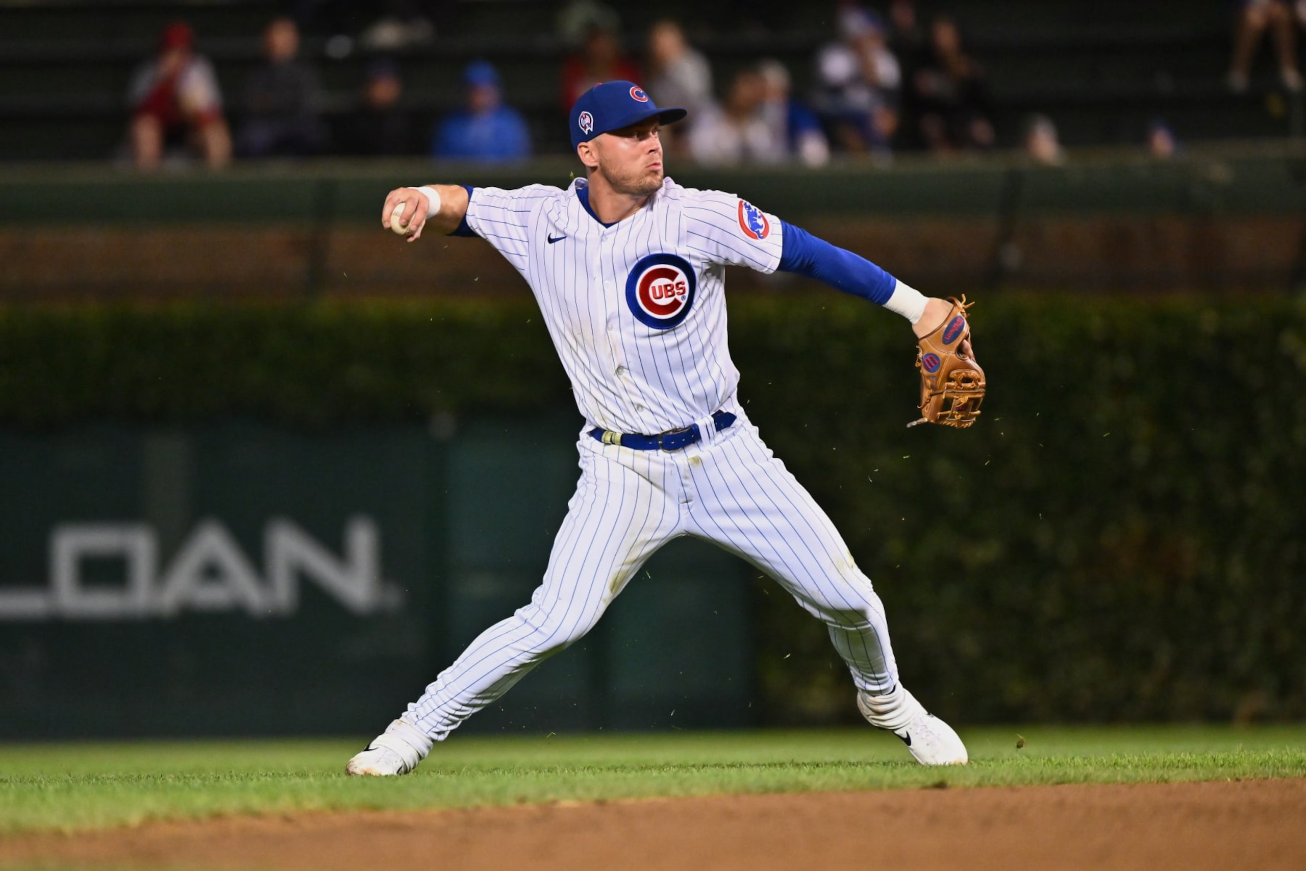 CHICAGO, IL - SEPTEMBER 11:  Nico Hoerner #2 of the Chicago Cubs throws to first base against the San Francisco Giants at Wrigley Field on September 11, 2022 in Chicago, Illinois.  (Photo by Jamie Sabau/Getty Images)