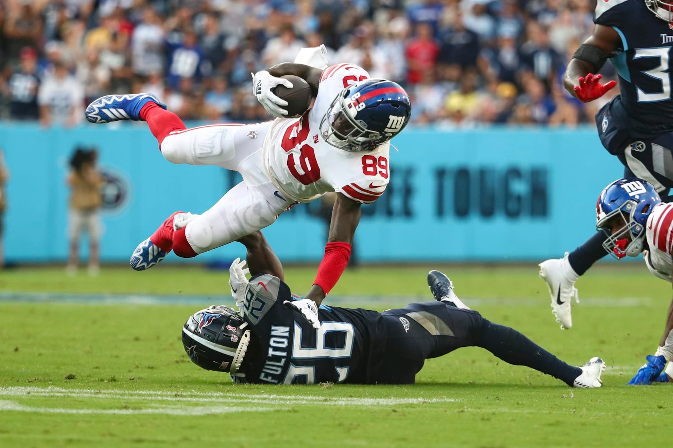 NASHVILLE, FL - SEPTEMBER 11: Kristian Fulton #26 of the Tennessee Titans tackles Kadarius Toney #89 of the New York Giants during an NFL football game at Nissan Stadium on September 11, 2022 in Nashville, Tennessee. (Photo by Kevin Sabitus/Getty Images)