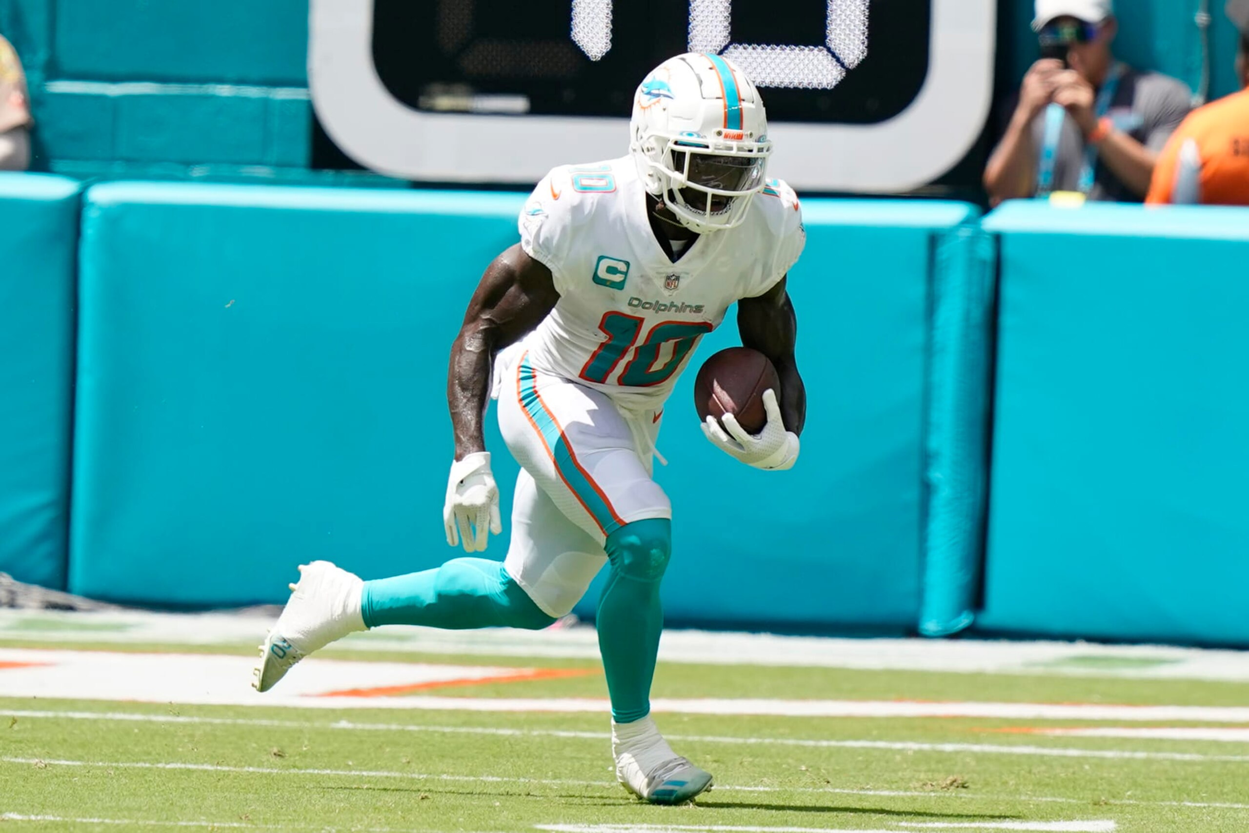 Miami Dolphins wide receiver Tyreek Hill (10) runs the ball during the first half of an NFL football game against the New England Patriots, Sunday, Sept. 11, 2022, in Miami Gardens, Fla. (AP Photo/Lynne Sladky)