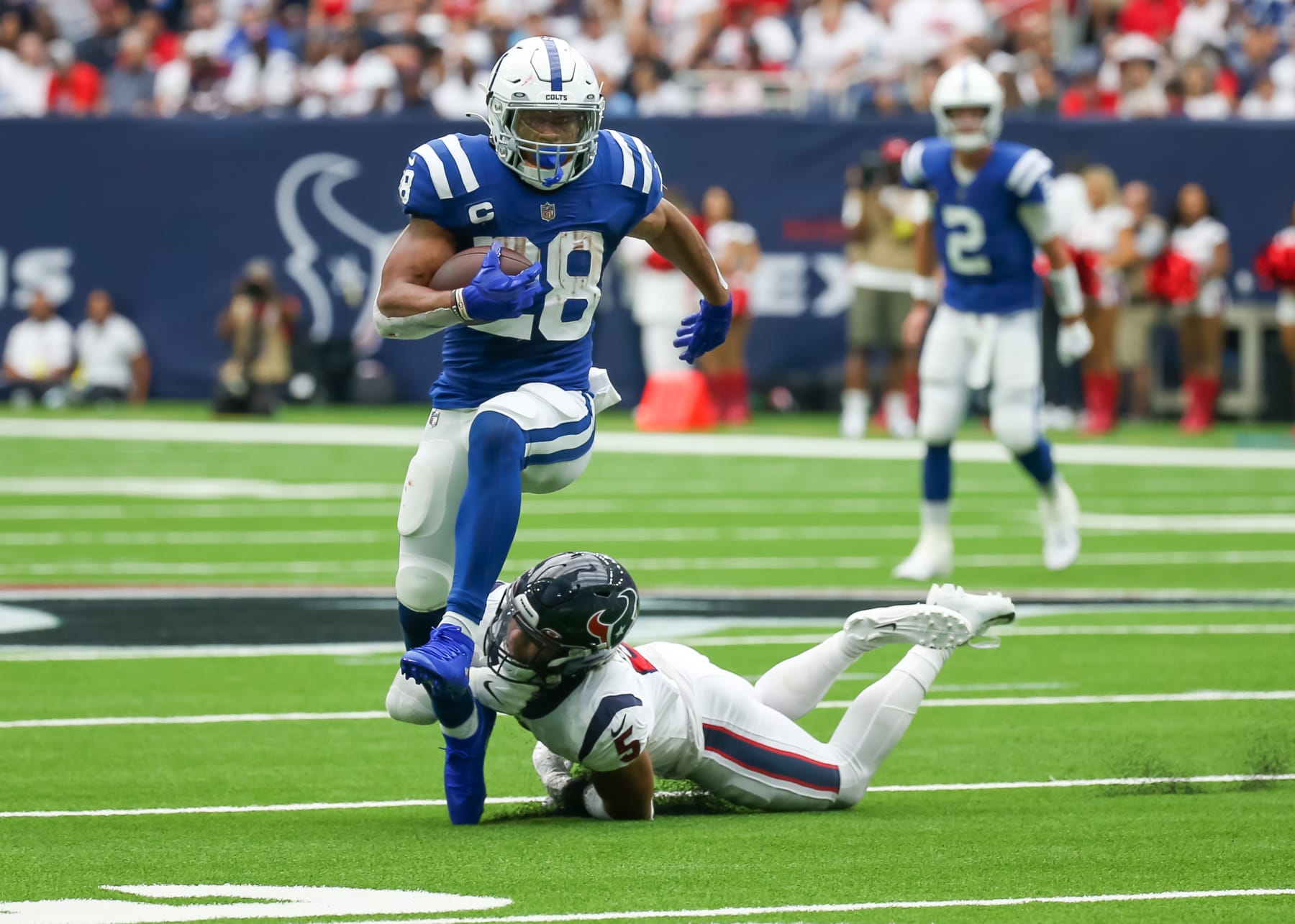 HOUSTON, TX - SEPTEMBER 11:  Indianapolis Colts running back Jonathan Taylor (28) avoids a tackle any Houston Texans safety Jalen Pitre (5) in the first quarter during the NFL game between the Indianapolis Colts and Houston Texans on September 11, 2022 at NRG Stadium in Houston, Texas.  (Photo by Leslie Plaza Johnson/Icon Sportswire via Getty Images)