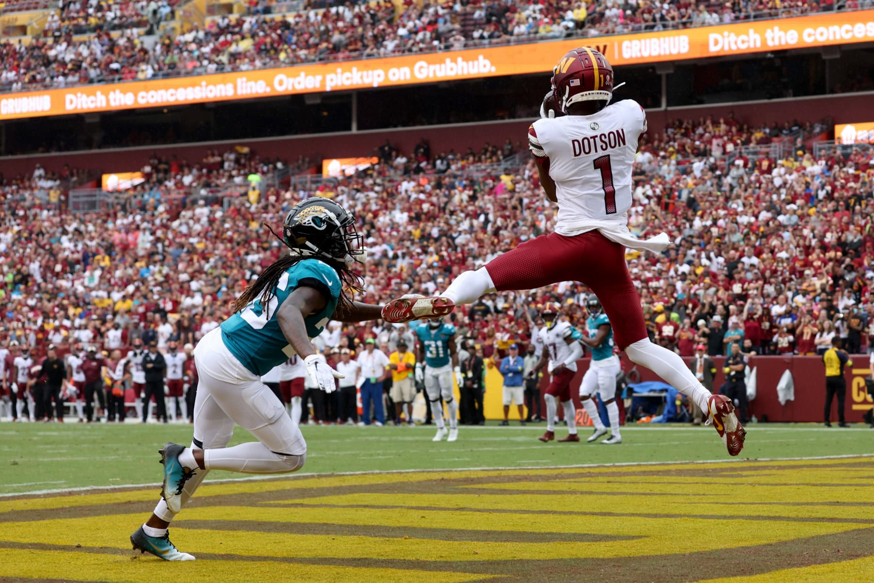 LANDOVER, MARYLAND - SEPTEMBER 11: Jahan Dotson #1 of the Washington Commanders catches a touchdown pass against Shaquill Griffin #26 of the Jacksonville Jaguars during the second quarter at FedExField on September 11, 2022 in Landover, Maryland. (Photo by Rob Carr/Getty Images)